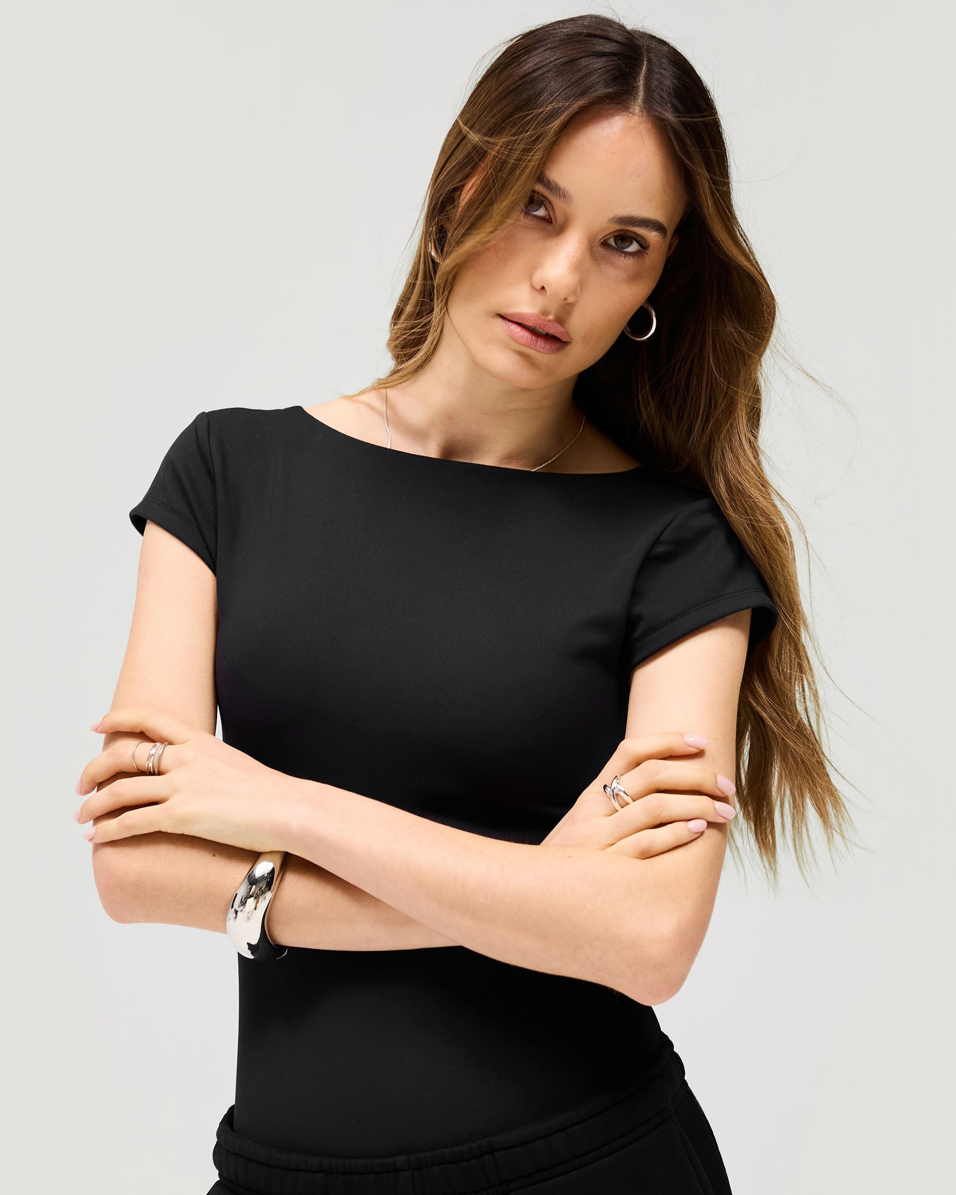 Back product image of a womens black bodysuit on a plain white background | Owners Club Bodysuit in Jet Black | Bodysuit with low scoop back and thong design | Womens Owners Club Tops | Represent Clo