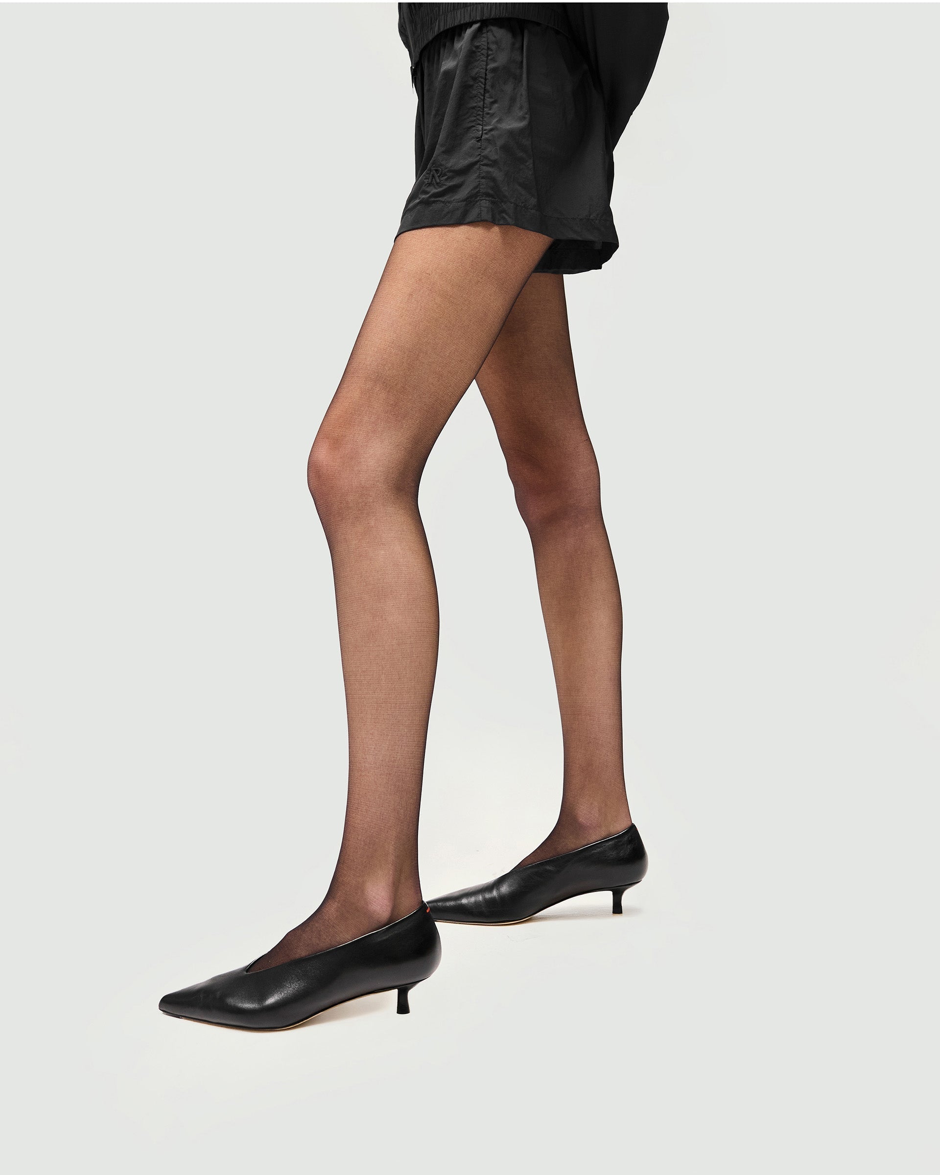 Back product image of womens black shorts on a plain white background | Underground Short in Jet Black | Regular fit nylon shorts with embroidered branding | Womens SS25 Shorts | Represent Clo