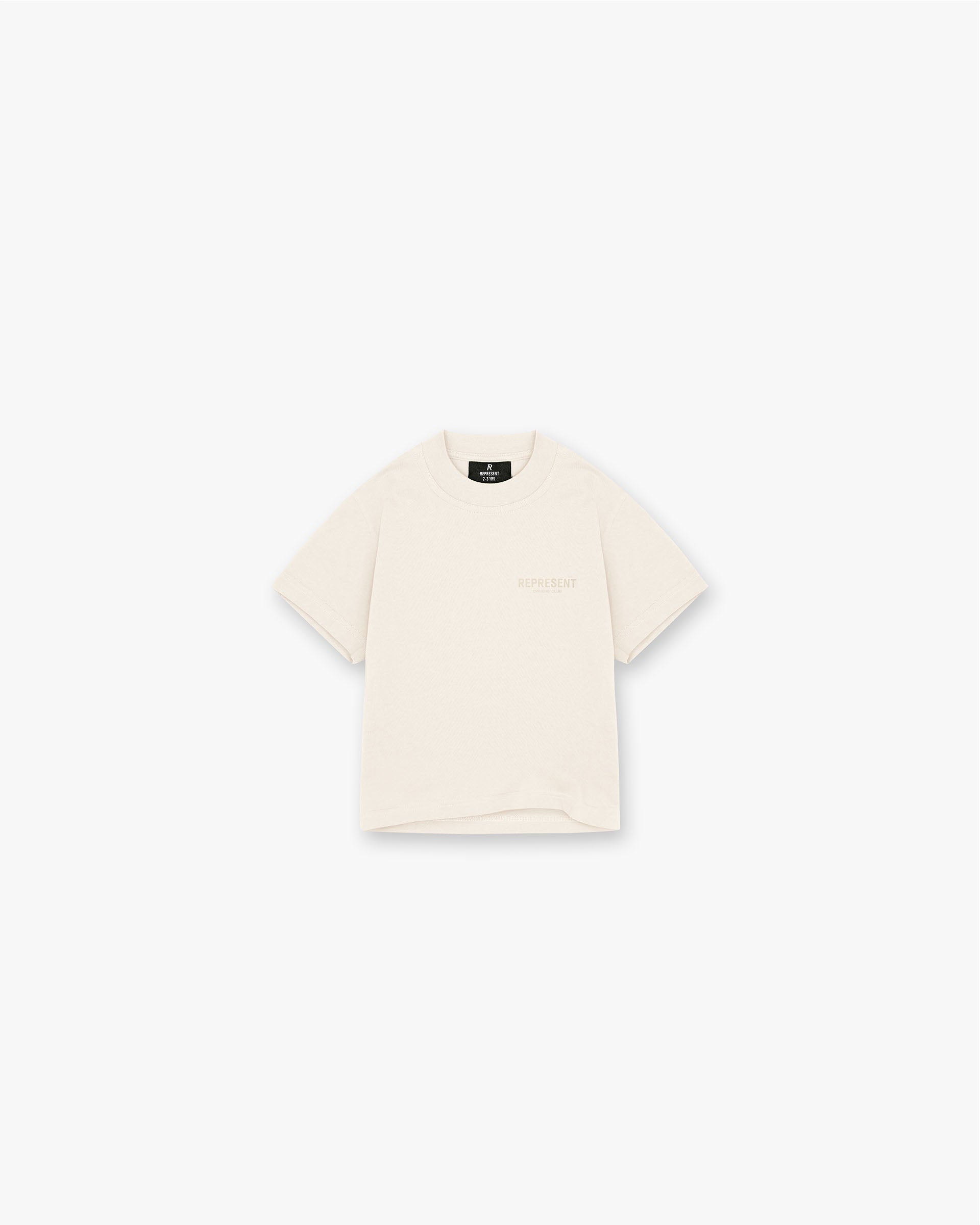 Front product image of a kids buttercream t-shirt on a plain white background | Represent Mini Owners Club T-Shirt in Buttercream | Slightly oversized t-shirt with puff print graphic | Mini Owners Club T-Shirts | Represent Clo