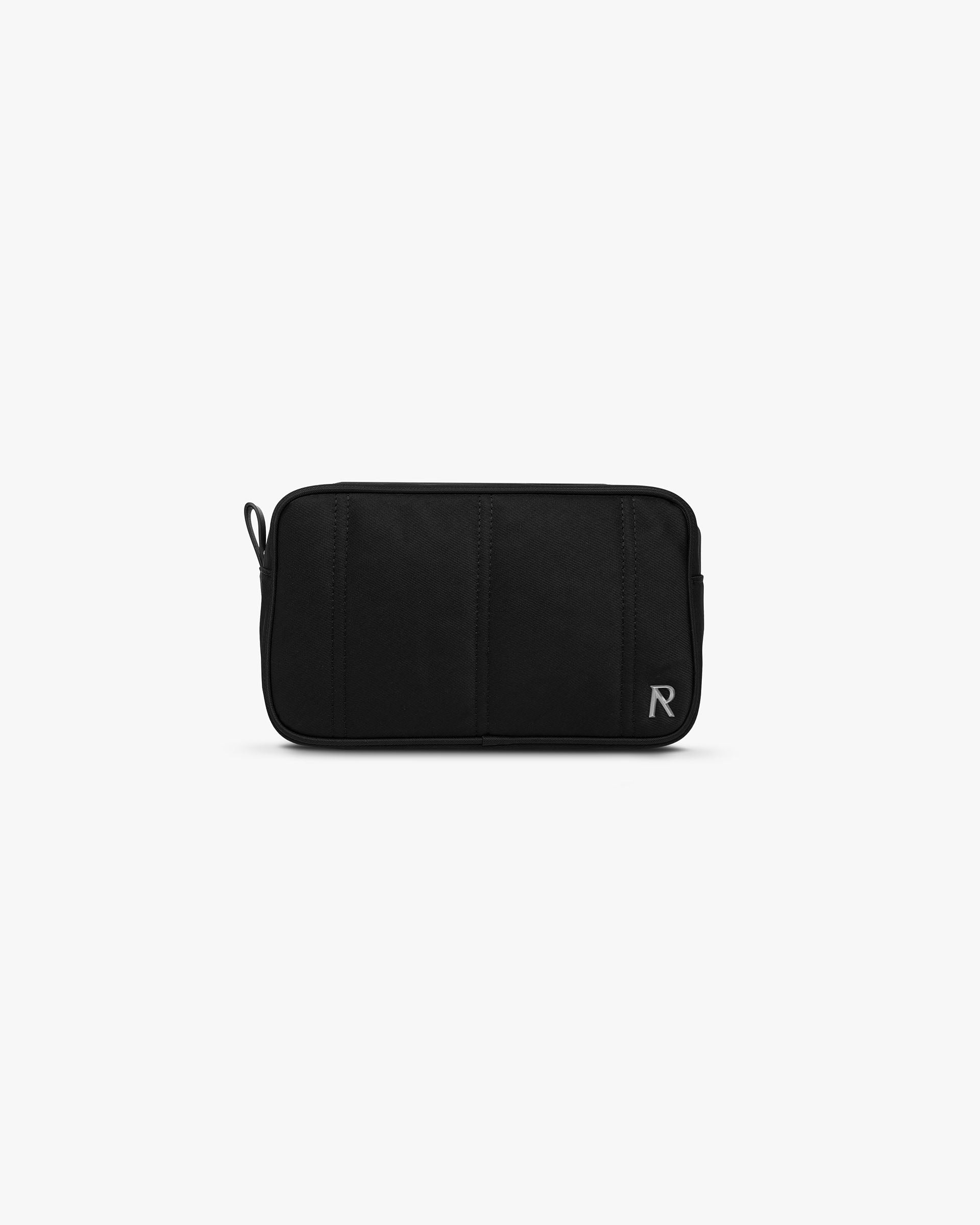 Front product image of a mens black wash bag on a plain white background | Quilted Wash Bag in Jet Black | Quilted accessory bag with seamless design | PRE SS25 Accessories | Represent Clo