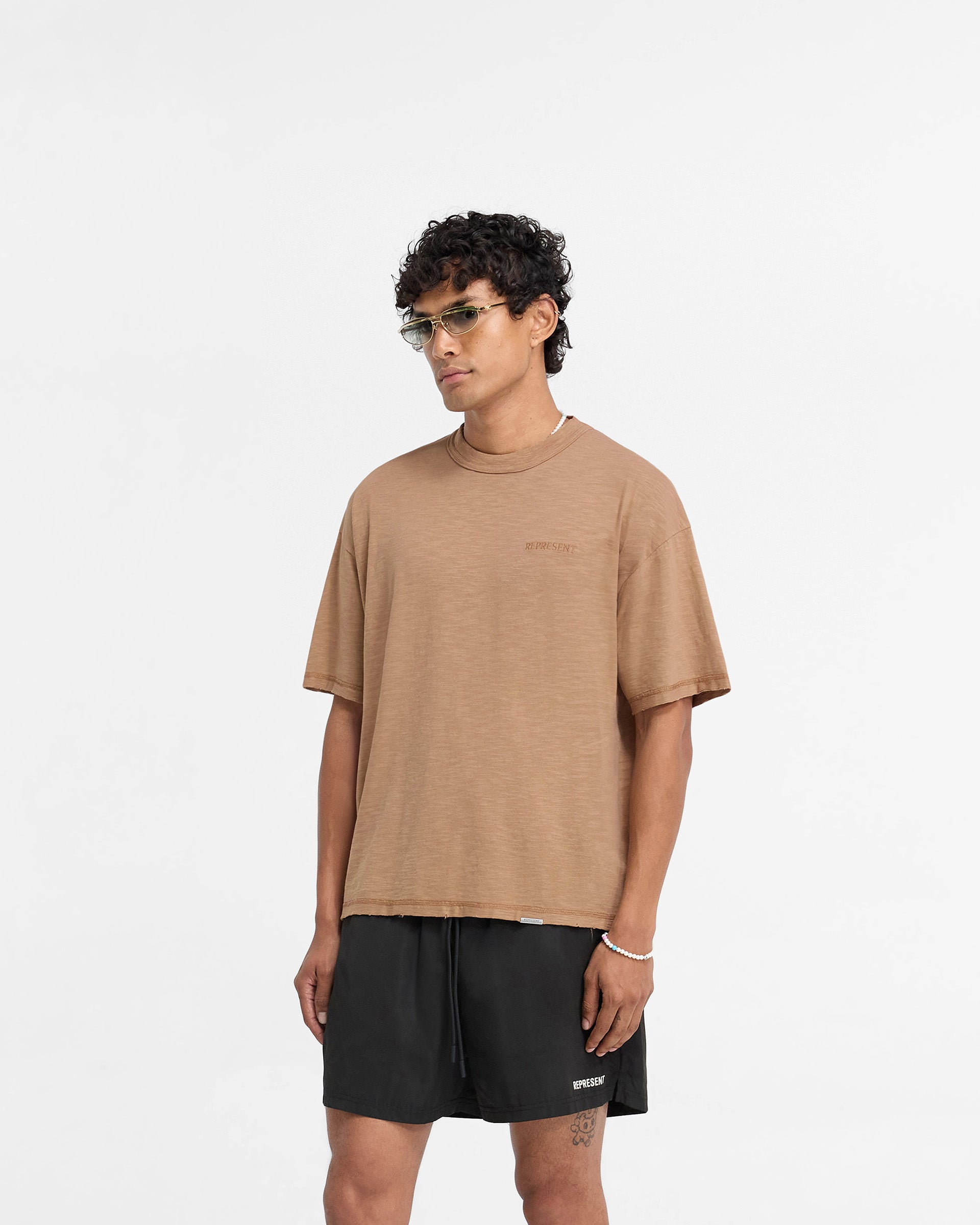 Back product image of a mens brown t-shirt on a plain white background | Slub T-Shirt in Walnut | Slightly oversized t-shirt with tonal embroidery | FW24 T-Shirts | Represent Clo