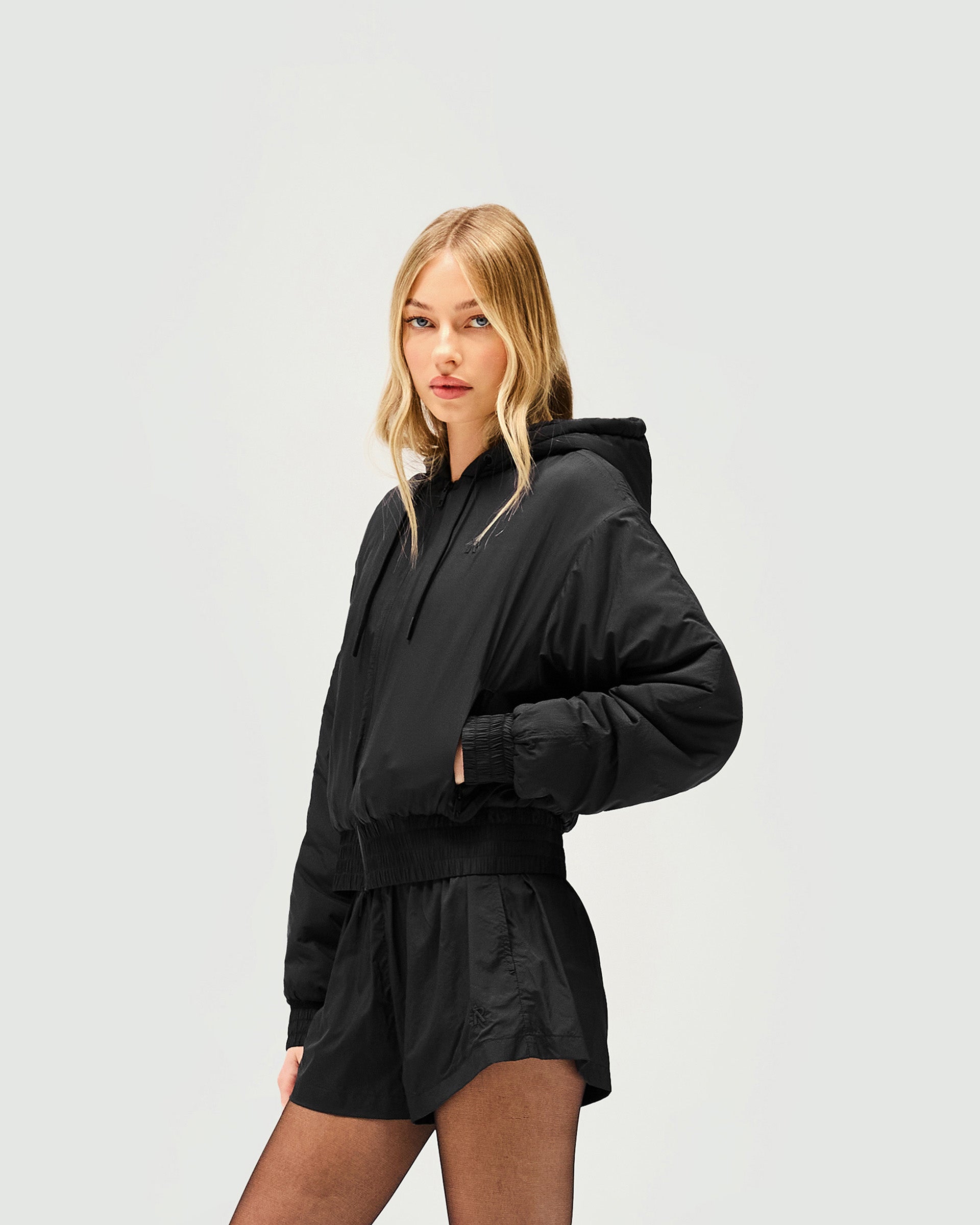Back product image of a womens black jacket on a plain white background | Underground Jacket in Jet Black | Nylon jacket with relaxed fit and silicon dipped drawcords | Womens SS25 Outerwear | Represent Clo