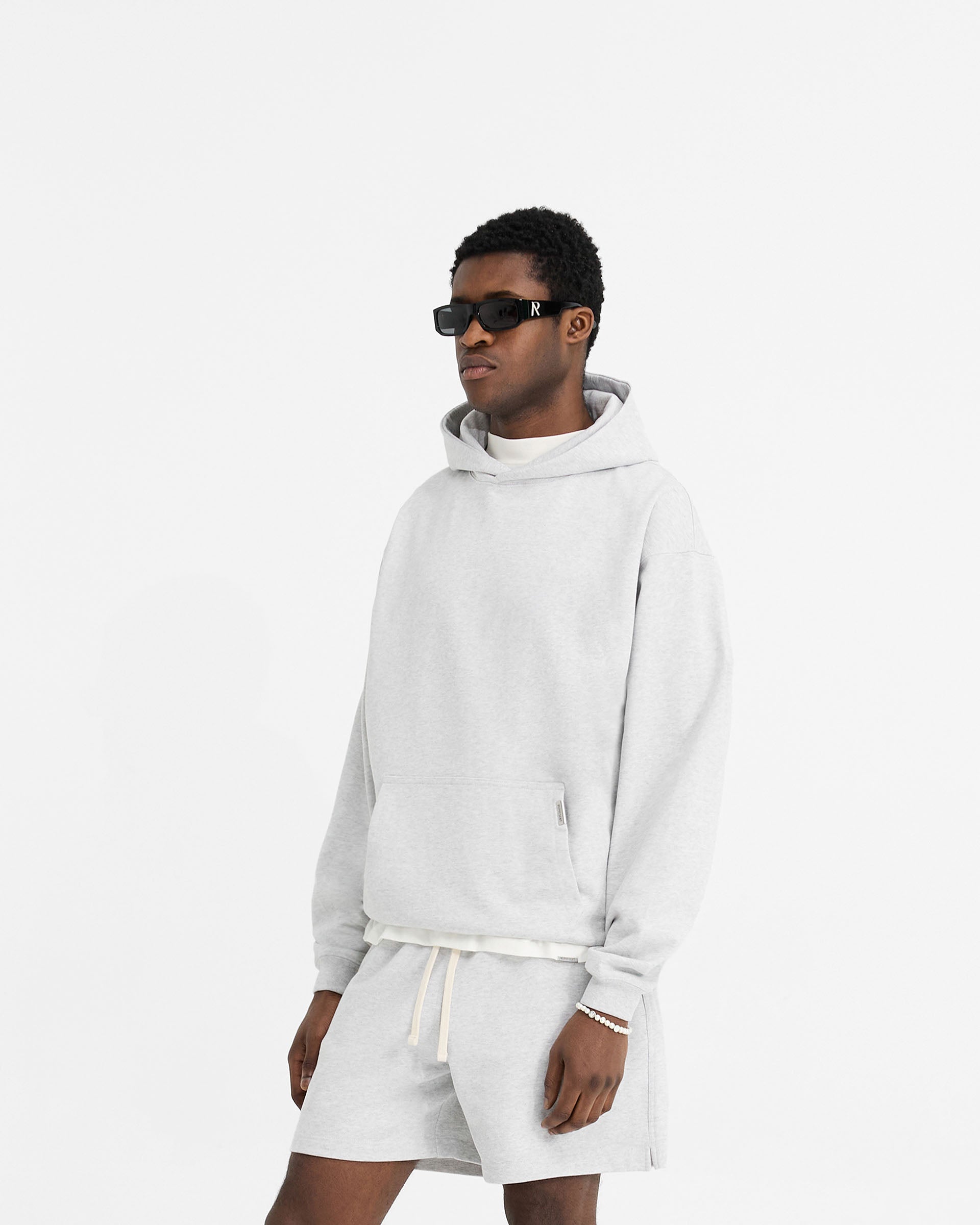 Back product image of a mens grey hoodie on a plain white background | Initial Oversized Hoodie in Ice Grey Marl | Heavyweight oversized fit hoodie with embroidered initial | Initial Hoodies | Represent Clo
