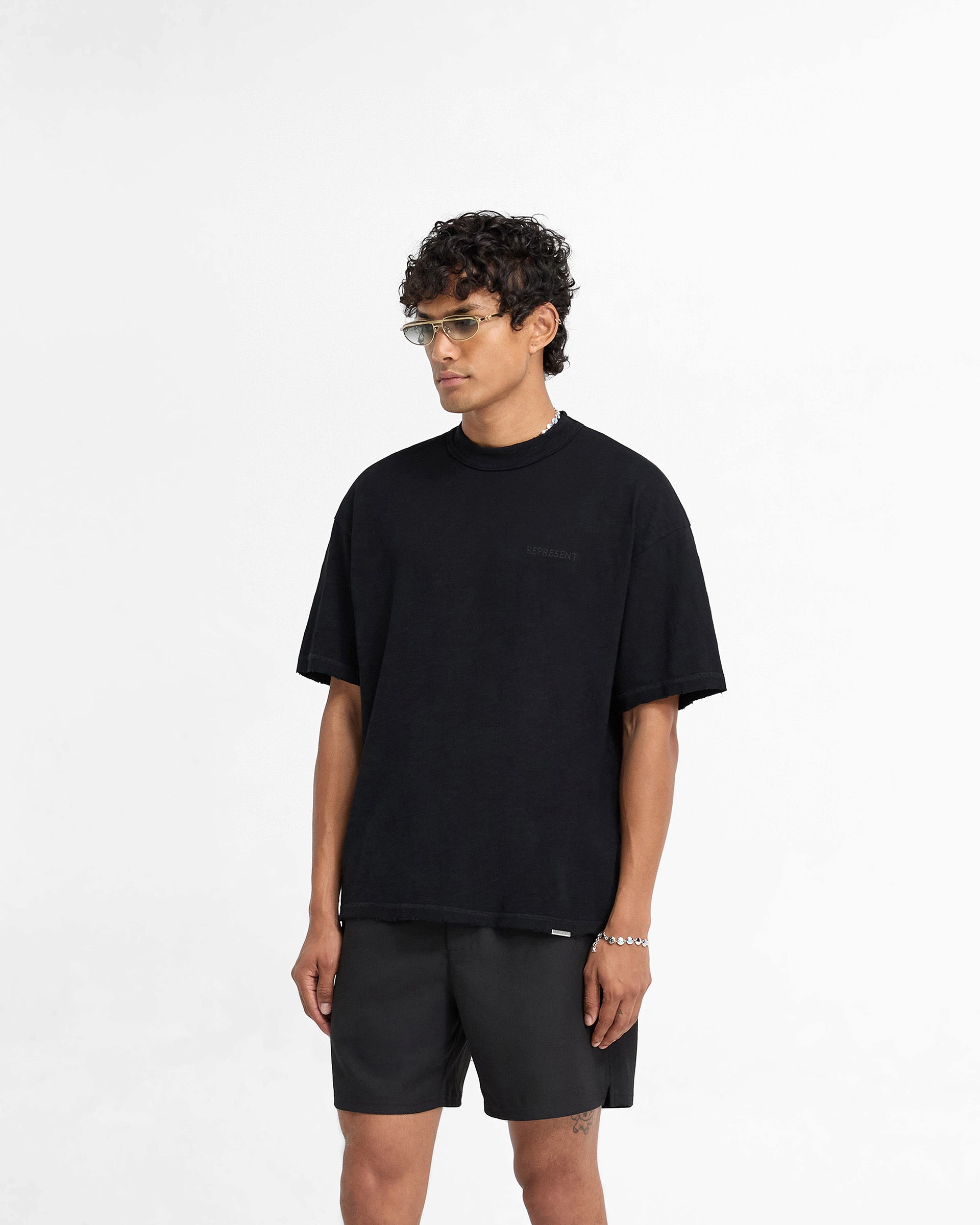 Back product image of a mens black t-shirt on a plain white background | Slub T-Shirt in Jet Black | Oversized t-shirt with tonal embroidery and distressed details | FW24 T-Shirts | Represent Clo