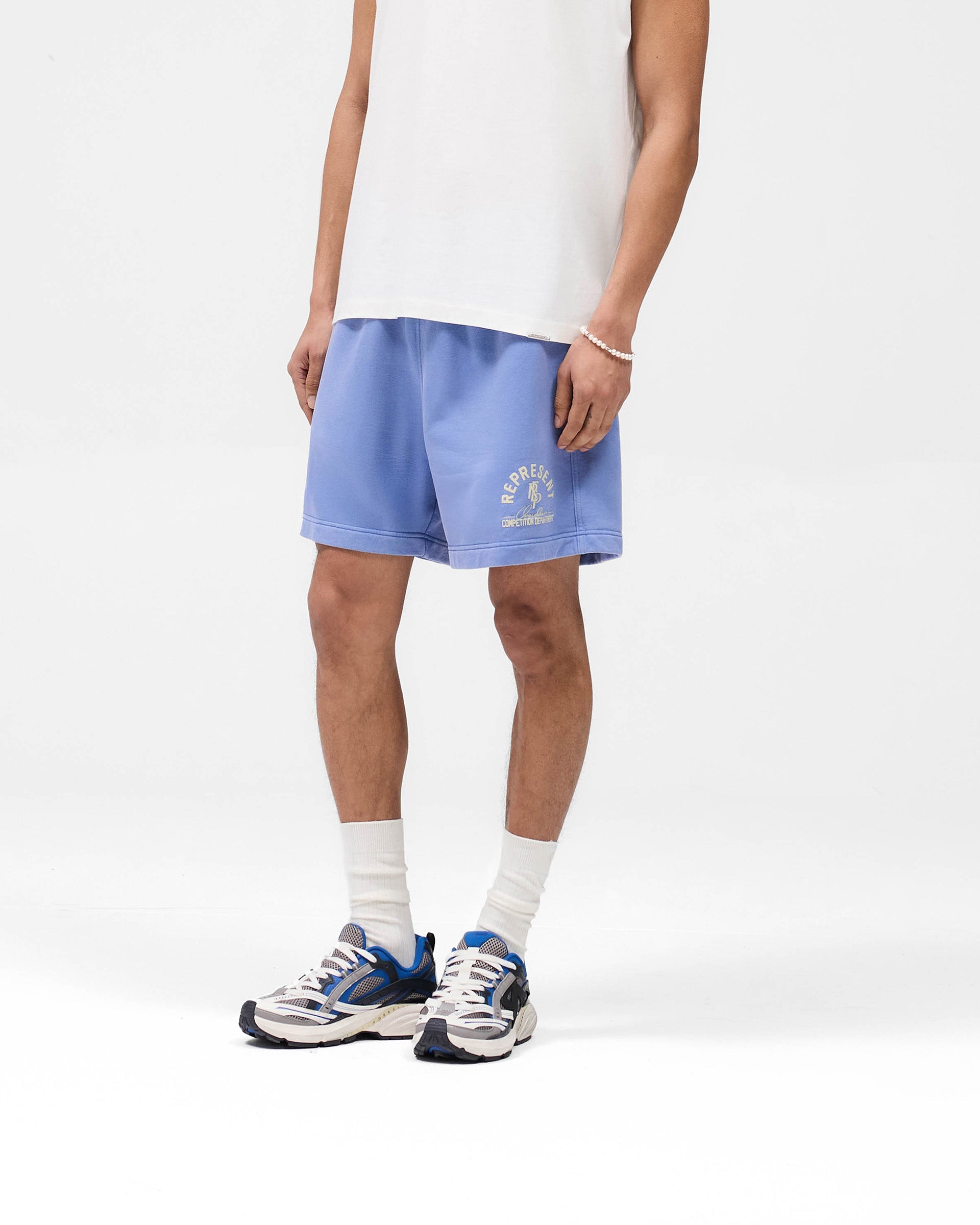 Back product image of mens blue shorts on a plain white background | Competition Department Shorts in Bright Blue | Graphic shorts with internal drawcord and vintage fade-out wash | SS25 Shorts | Represent Clo