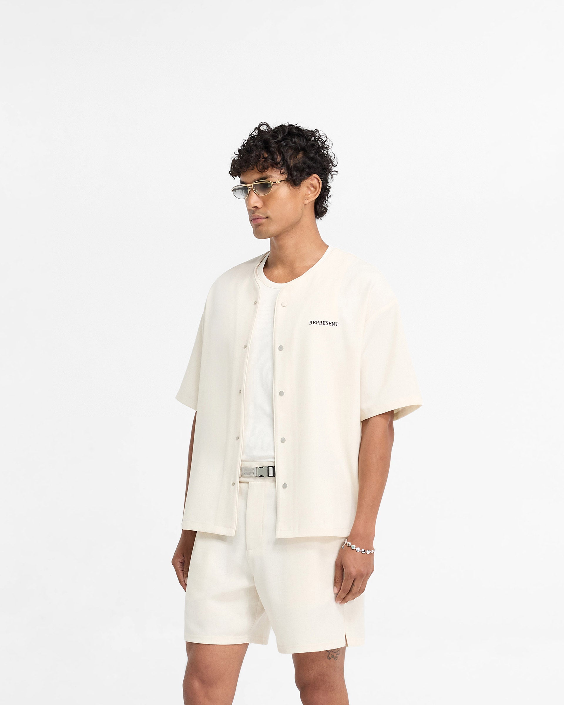 Back product image of a mens white shirt on a plain white background | Baseball Shirt in Antique White | Collarless shirt with popper buttons | FW24 Shirts | Represent Clo