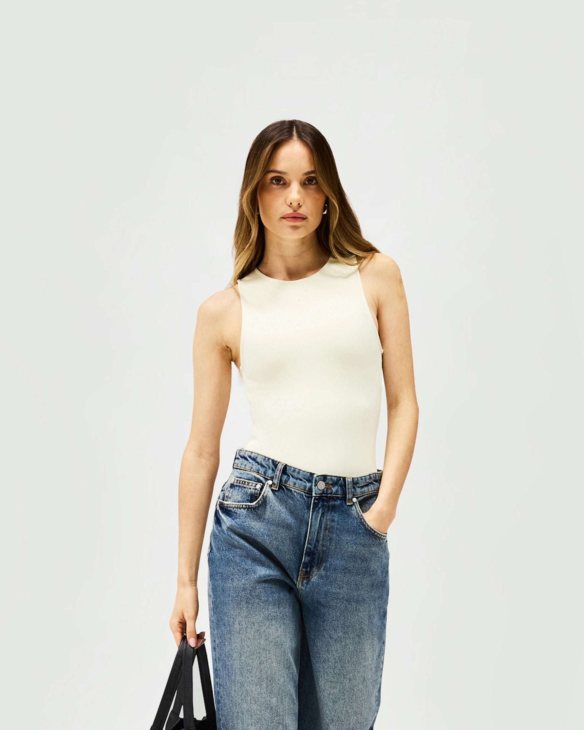 Back product image of a womens white bodysuit on a plain white background | Control Bodysuit in Warm White | Bodysuit with rounded neckline and thong back | Womens SS25 Tops | Represent Clo
