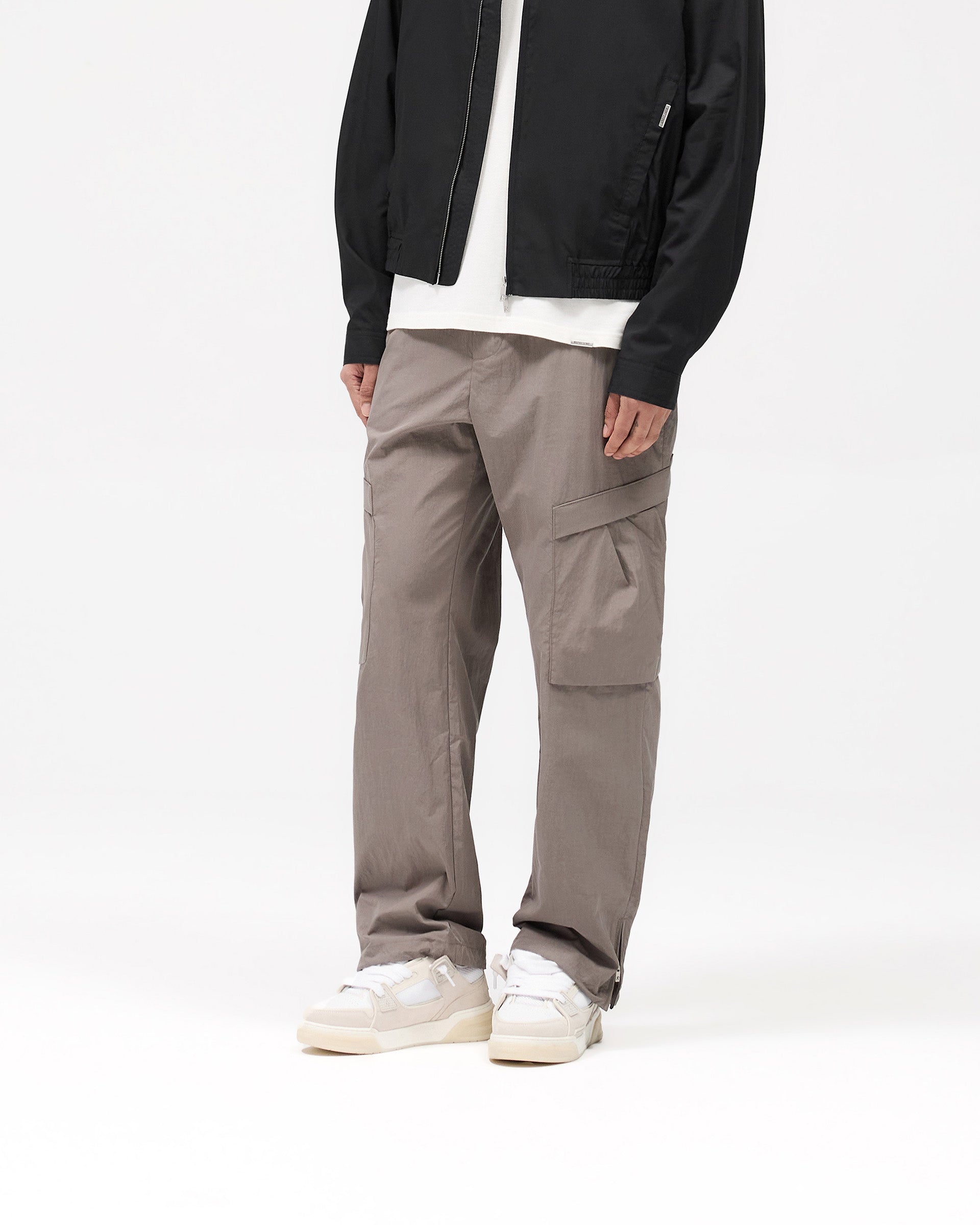 Back product image of mens grey pants on a plain white background | Tech Cargo Pant in Mid Grey | Pants with pleated cargo pockets and adjustable hem zip | SS25 Pants | Represent Clo