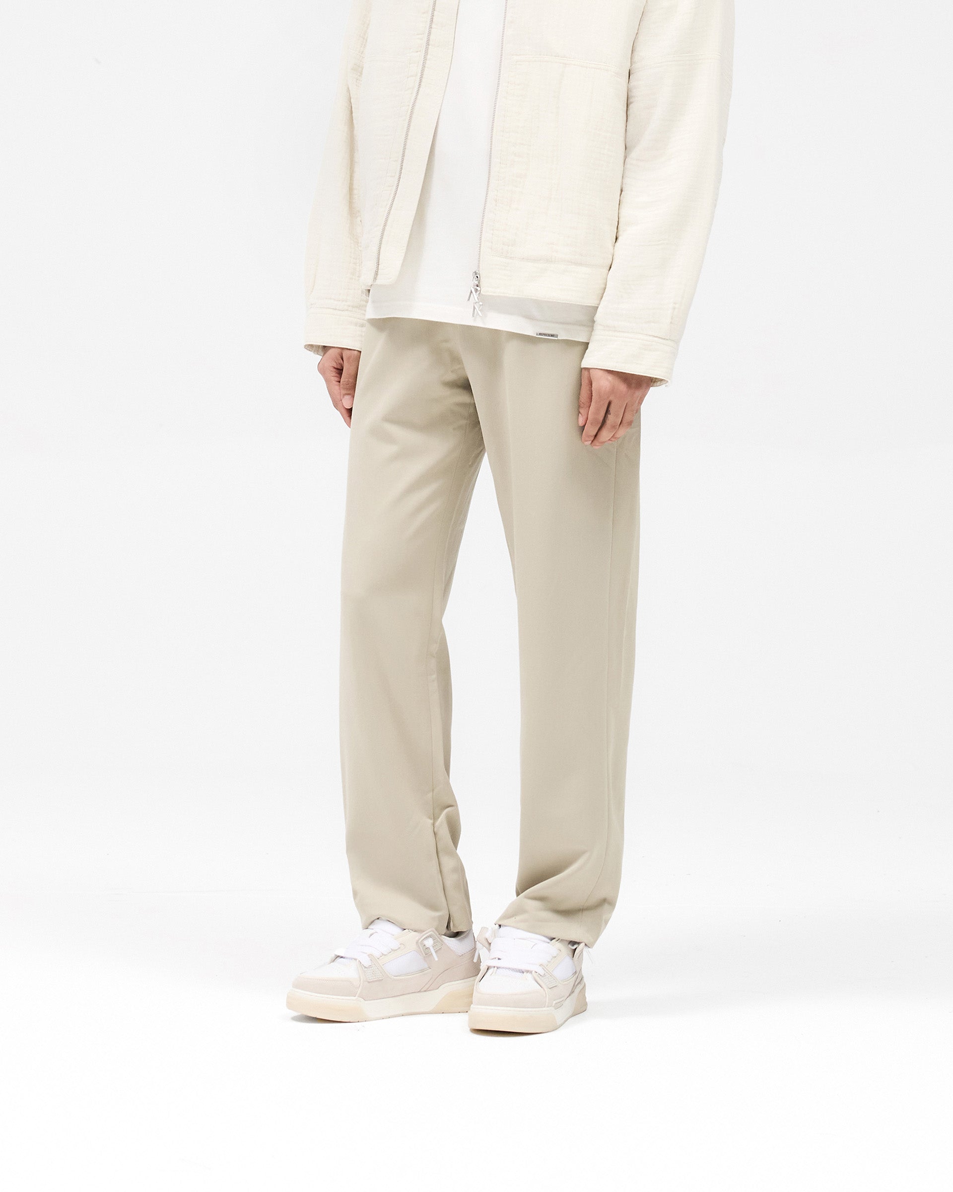 Back product image of mens grey pants on a plain white background | Core Pant in Light Grey | Pants with hybrid-style elasticated waistband and concealed zip | SS25 Pants | Represent Clo