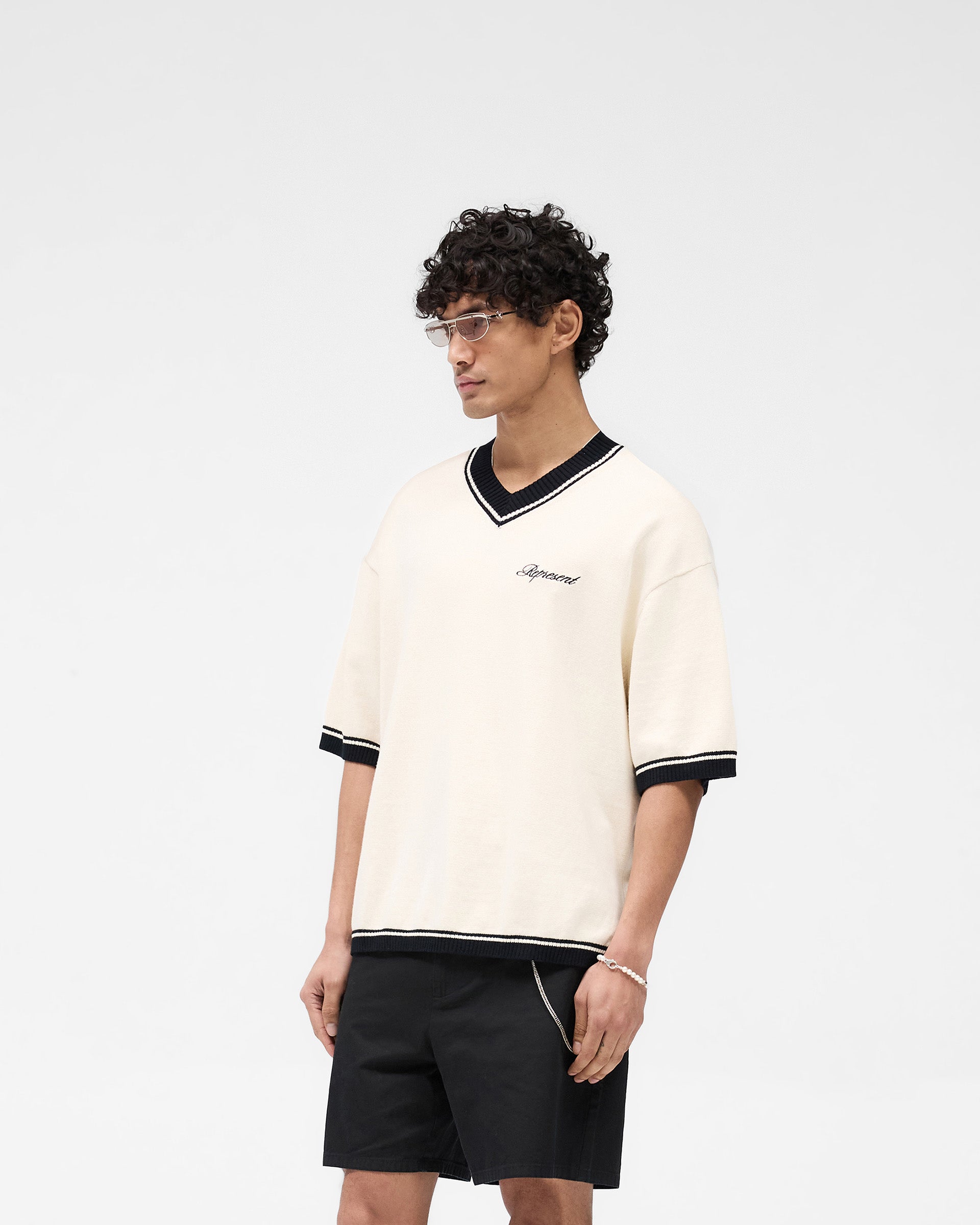 Back product image of a mens white knit on a plain white background | Script Embroidered Knit in Off White | Knitwear with ribbed cuffs and hem | SS25 Knitwear | Represent Clo