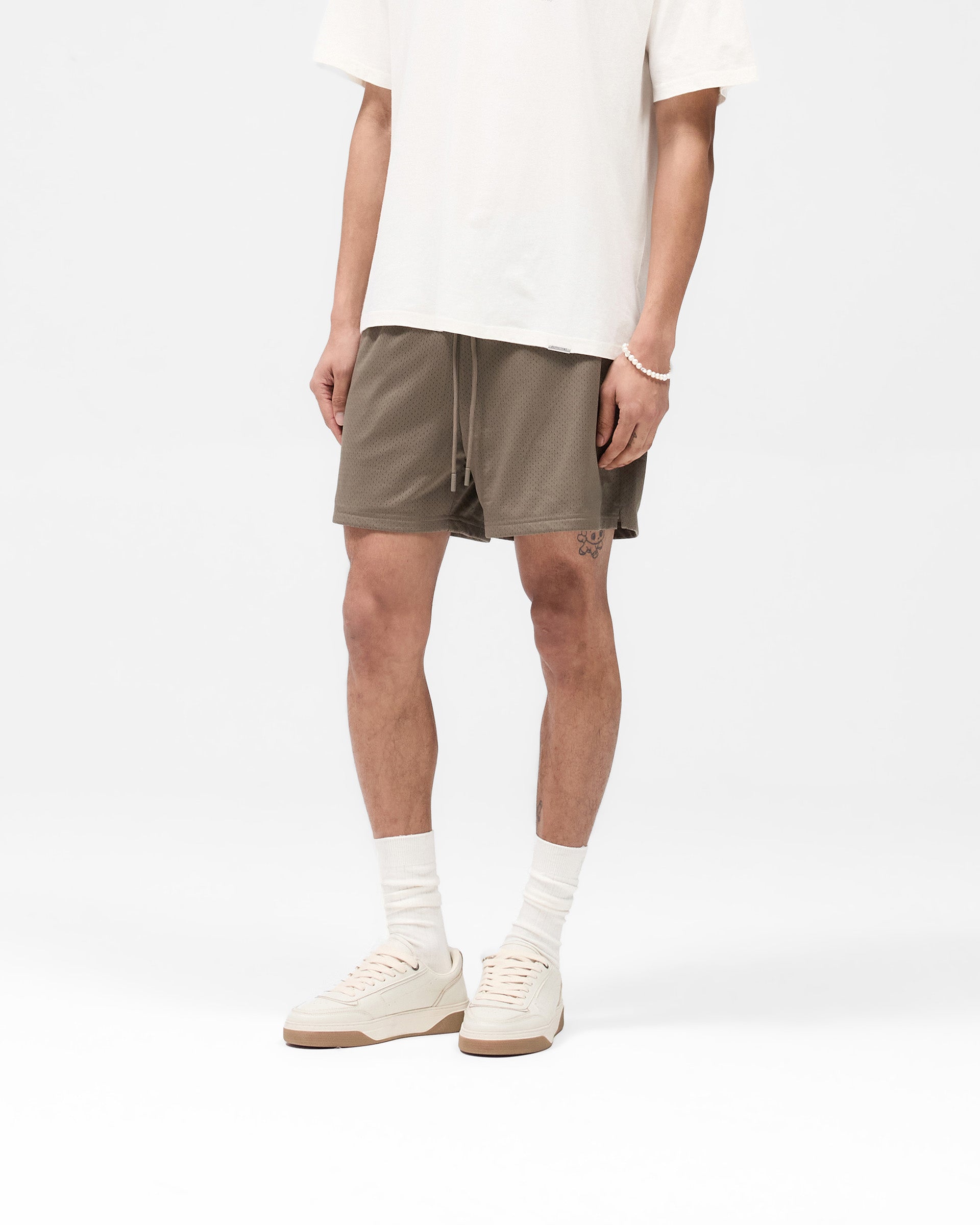 Back product image of mens stone mesh shorts on a plain white background | Mesh Short in Stone | Mesh shorts with zip pockets and internal drawcord | SS25 Shorts | Represent Clo