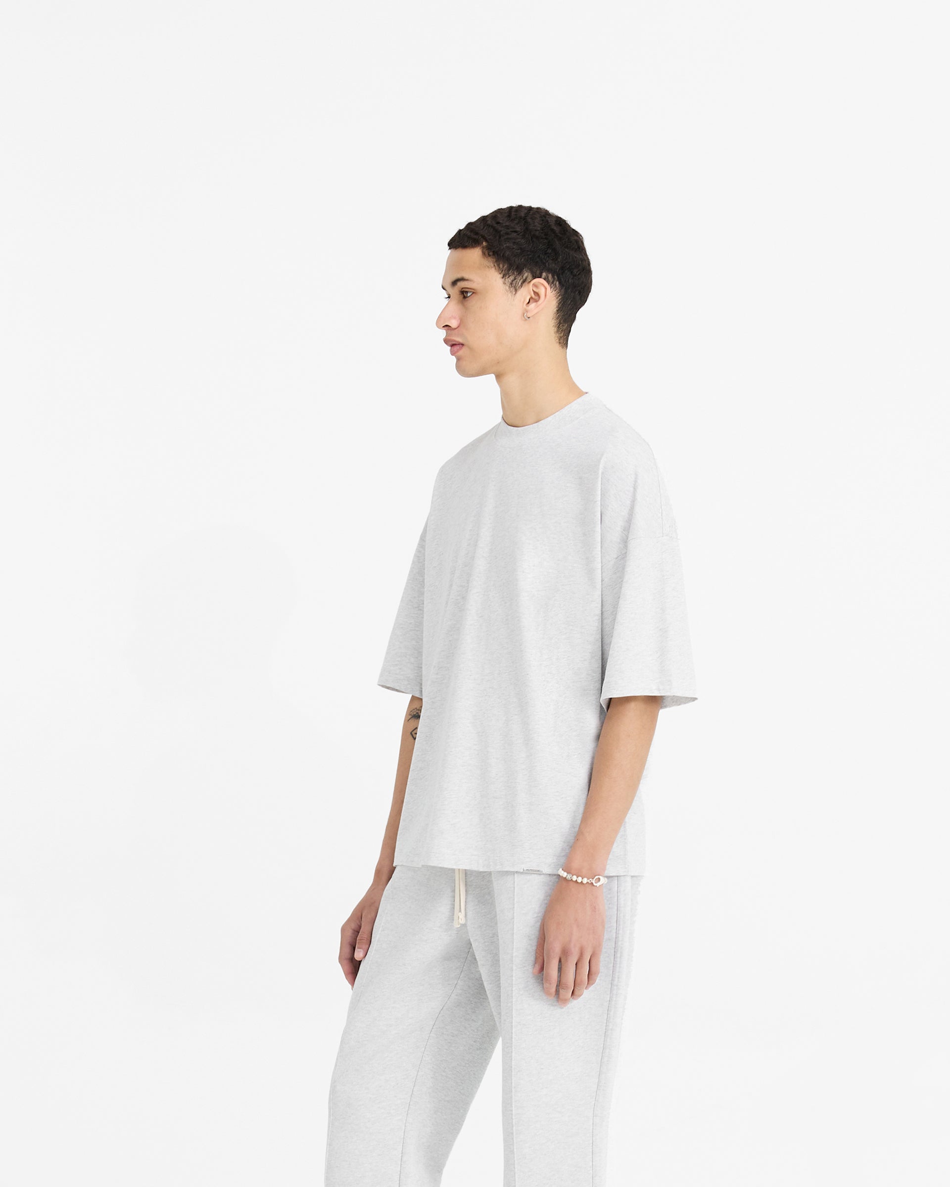 Back product image of a mens grey t-shirt on a plain white background | Initial Boxy T-Shirt in Ice Grey Marl | Super oversized boxy cropped t-shirt | Initial T-Shirts | Represent Clo