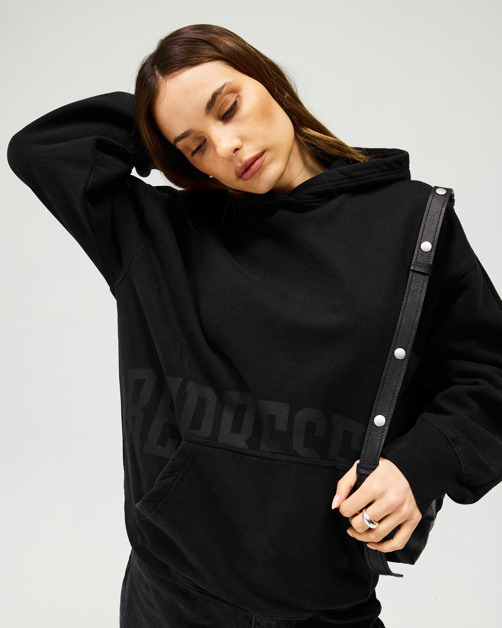 Back product image of a womens brown hoodie on a plain white background | Boyfriend Graphic Hoodie in Black Coffee | Hoodie with relaxed oversized fit and tonal branding | Womens SS25 Hoodies | Represent Clo