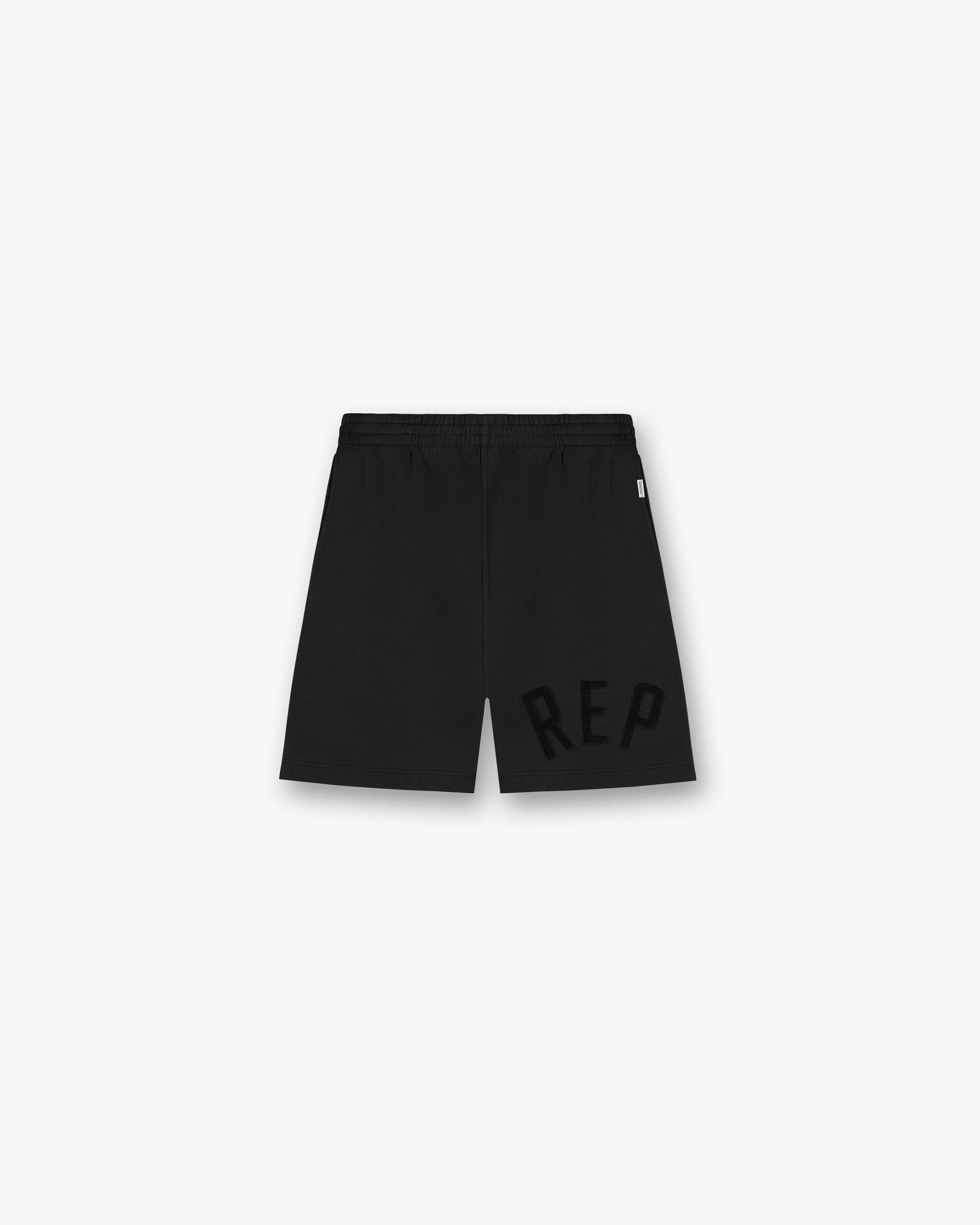 Front product image of mens black shorts on a plain white background | Rep Applique Shorts in Off Black | Viscose shorts with forest print in orange | SS25 Shorts | Represent Clo