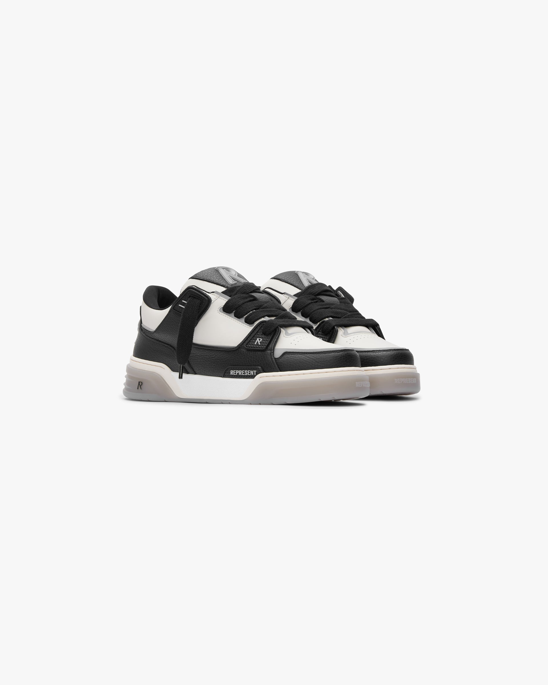Back product image of a mens black and white sneaker on a plain white background | Studio Sneaker in Black Vintage White | Leather sneaker with TPU trims and tri-color rubber outsole | SS24 Footwear | Represent Clo