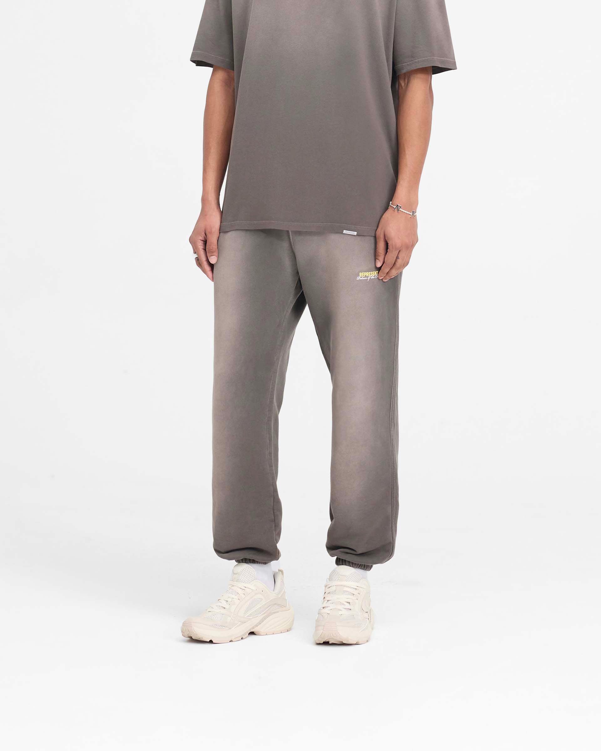 Back product image of mens olive sweatpants on a plain white background | Patron Of The Club Sweatpant in Washed Olive | Sweatpants with elasticated waistband and cuffs | Patrons Pants | Represent Clo