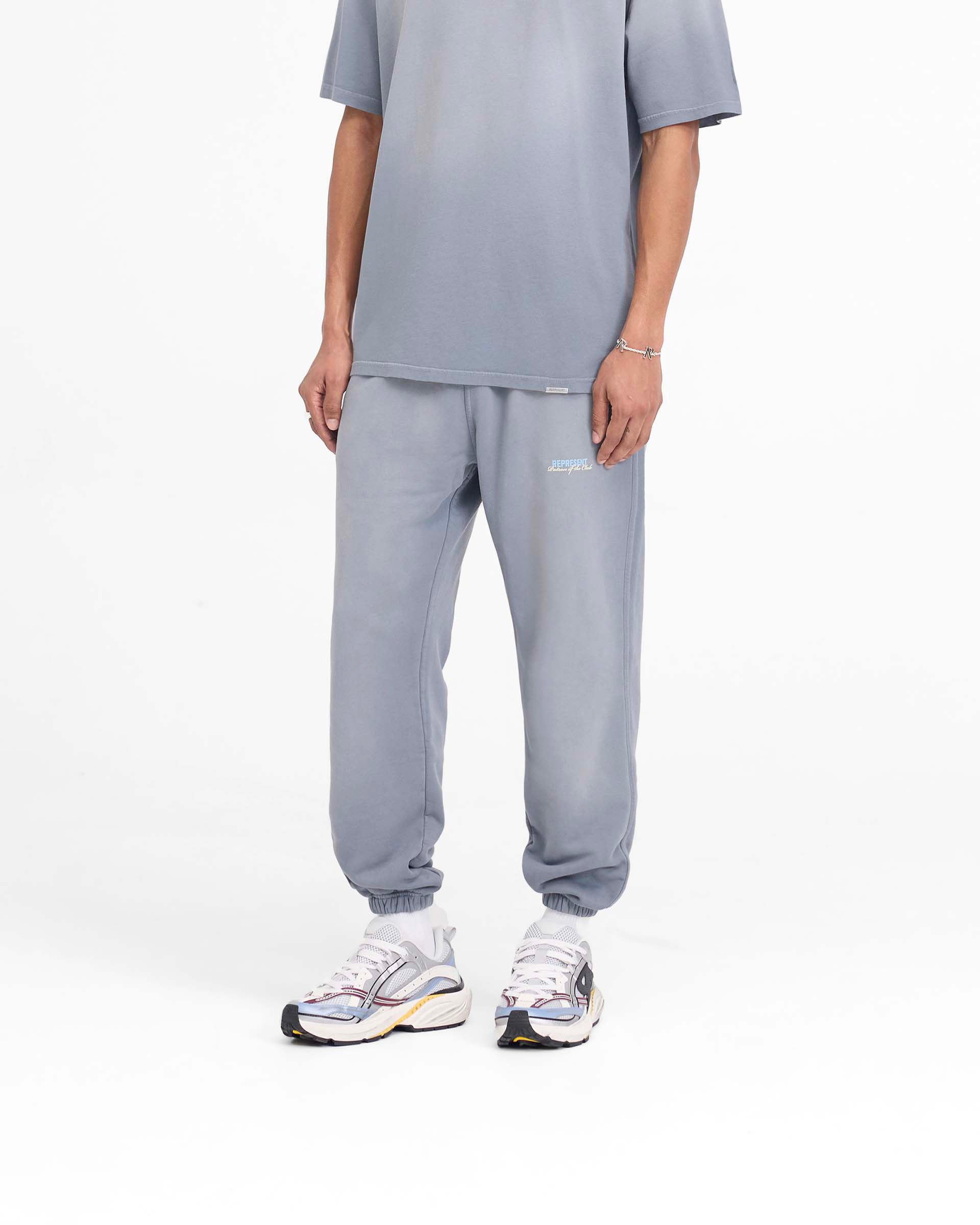 Back product image of mens grey sweatpants on a plain white background | Patron Of The Club Sweatpant in Washed Grey | Sweatpants with elasticated waistband and cuffs | Patrons Pants | Represent Clo