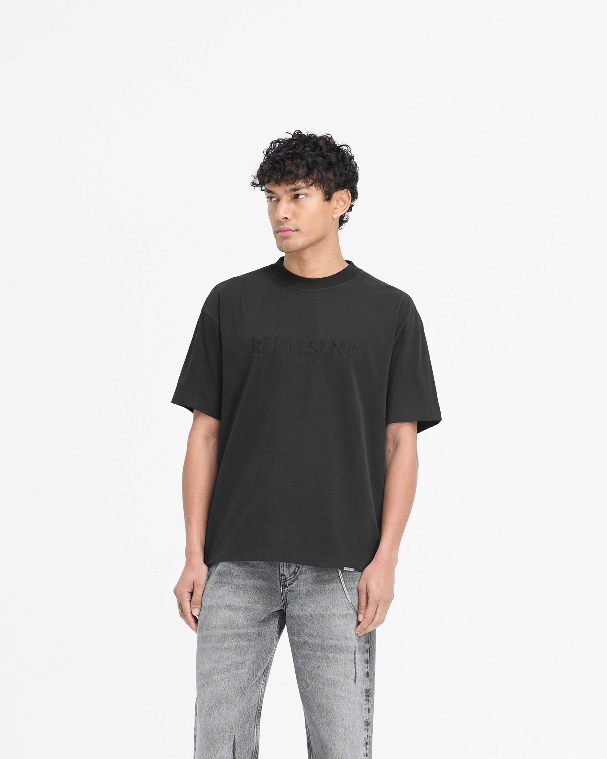 Back product image of a mens black t-shirt on a plain white background | Serif Logo T-Shirt in Jet Black | Oversized t-shirt with embroidered branding | PRE SS25 T-Shirts | Represent Clo