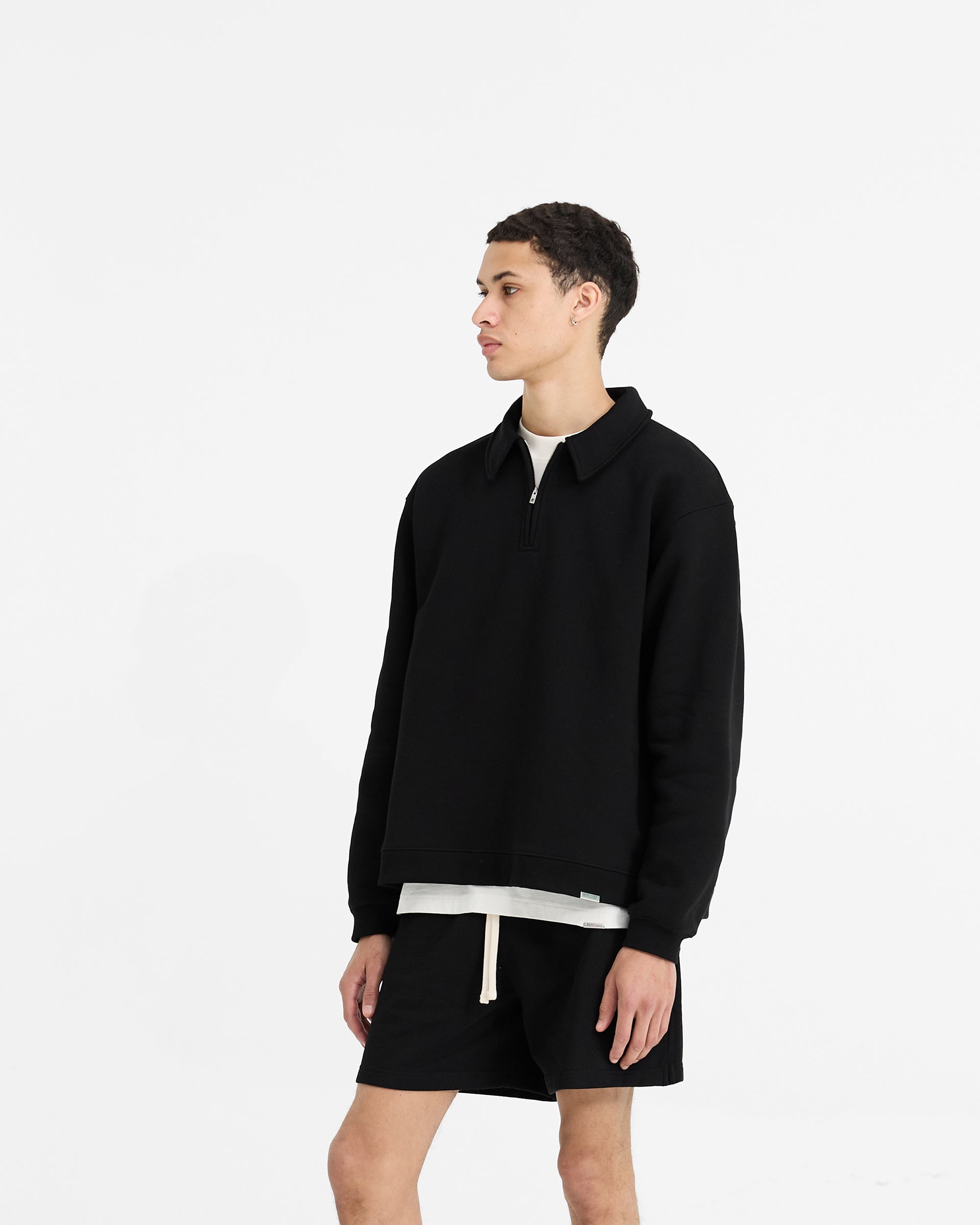 Back product image of a mens black sweater on a plain white background | Initial Boxy Quarter Zip in Black | Sweater with boxy fit and RiRi zip | Initial Sweaters | Represent Clo