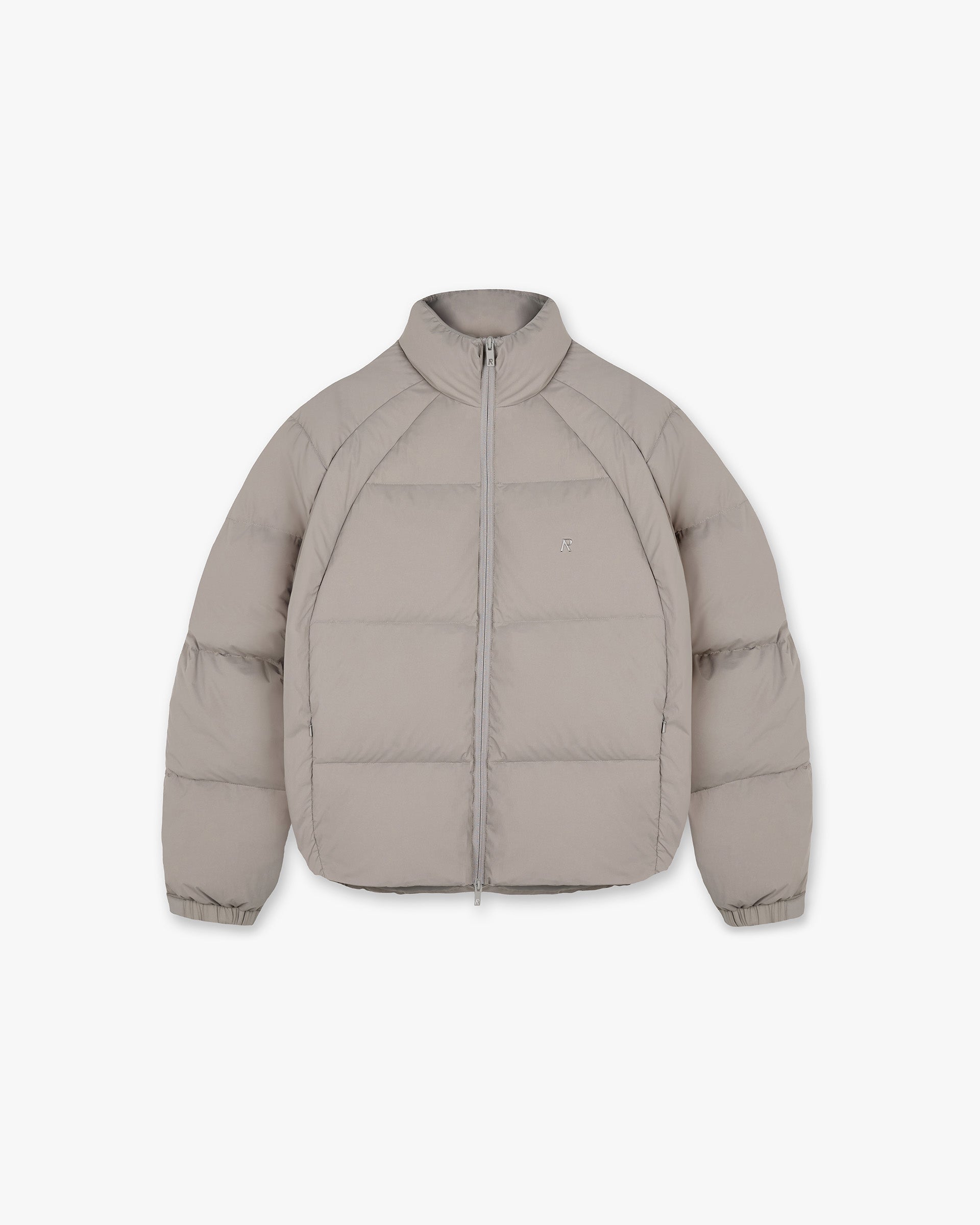 Front product image of a mens beige puffer jacket on a plain white background | Funnel Neck Puffer in Dune | Puffer jacket with funnel neck design | PRE SS25 Outerwear | Represent Clo