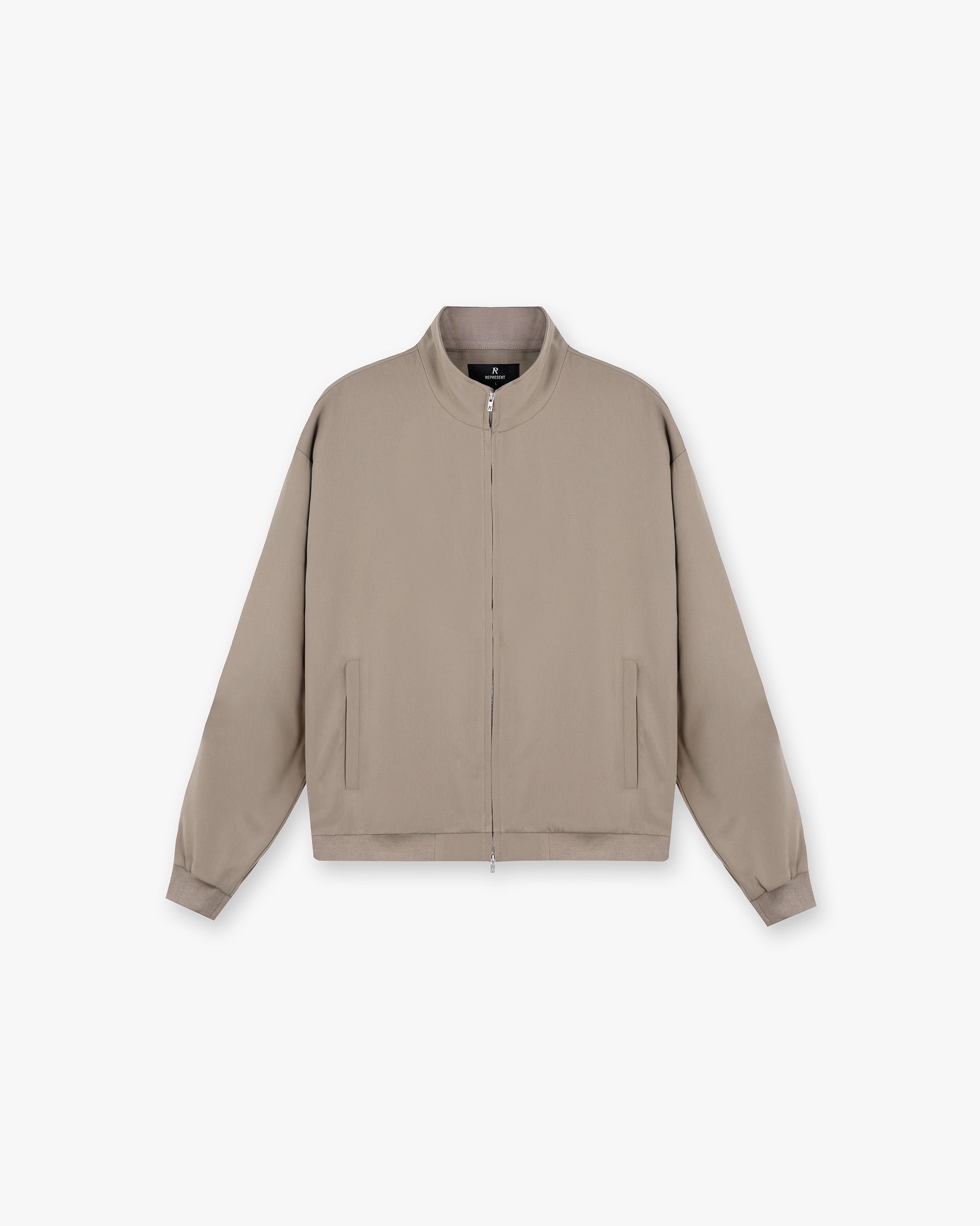 Front product image of a mens beige track jacket on a plain white background | Initial Track Jacket in Dune | Outerwear track jacket | Initial Outerwear | Represent Clo