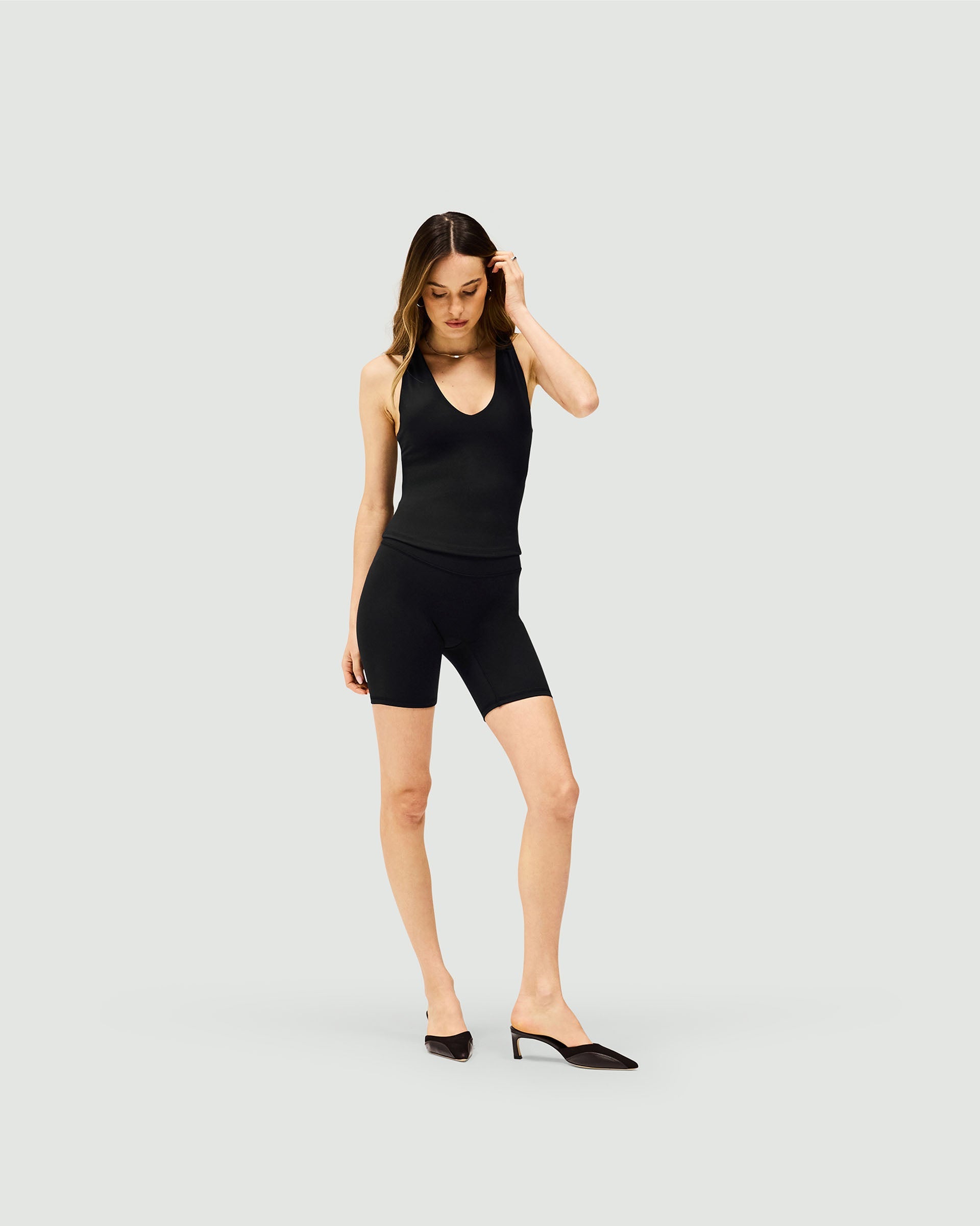 Back product image of womens black bike shorts on a plain white background | Owners Club Longerline Bike Short in Jet Black | No front seams and sculpting detail | Womens Owners Club Shorts | Represent Clo