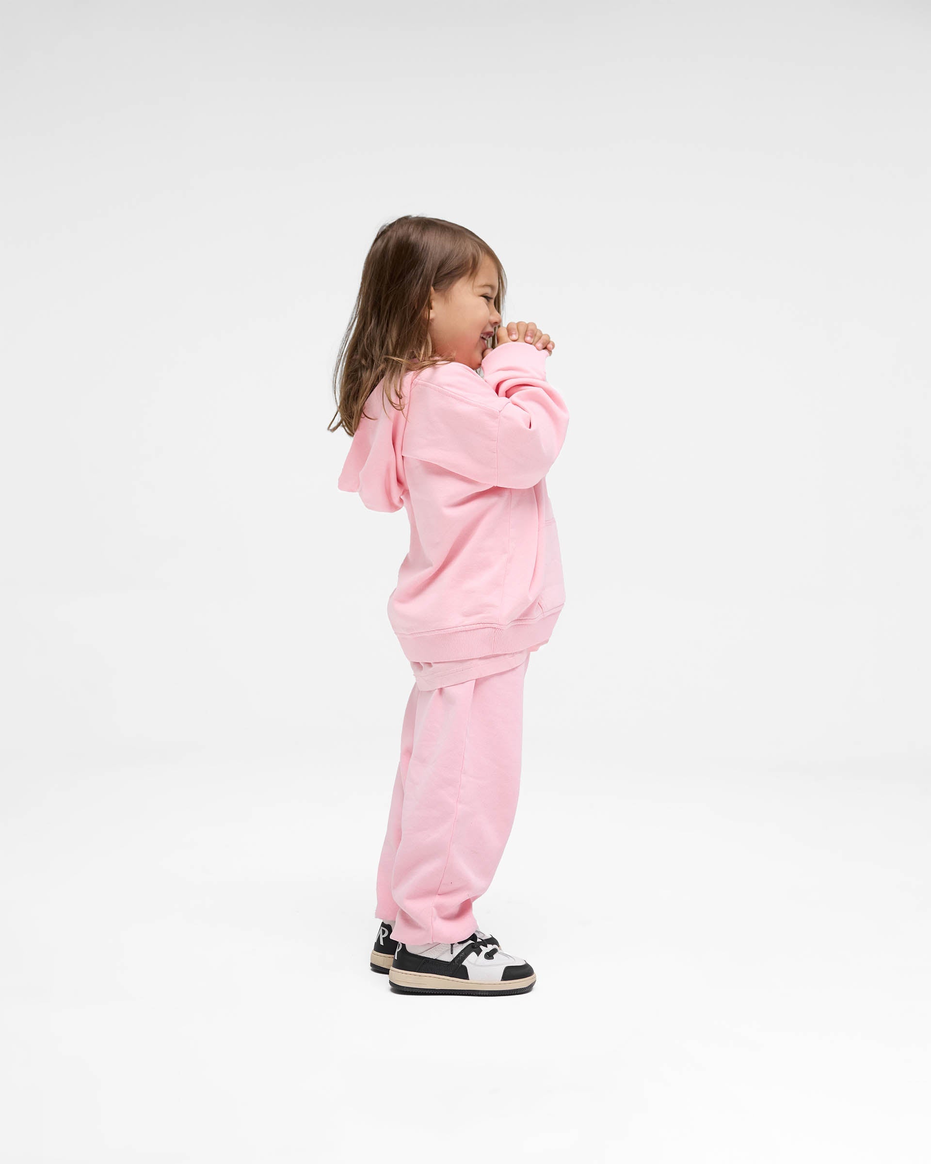 Back product image of kids pink sweatpants on a plain white background | Mini Rep Applique Sweatpants in Candy Pink | Sweatpants with elasticated waistband and distressed applique logo | FW24 Pants | Represent Clo