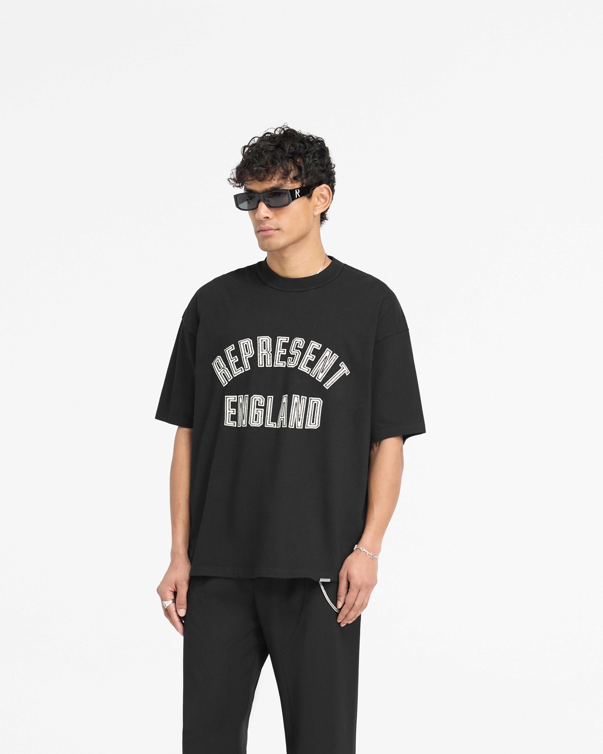 Back product image of a mens black t-shirt on a plain white background | England Applique T-Shirt in Jet Black | Slightly oversized heavier weight t-shirt | PRE SS25 T-Shirts | Represent Clo