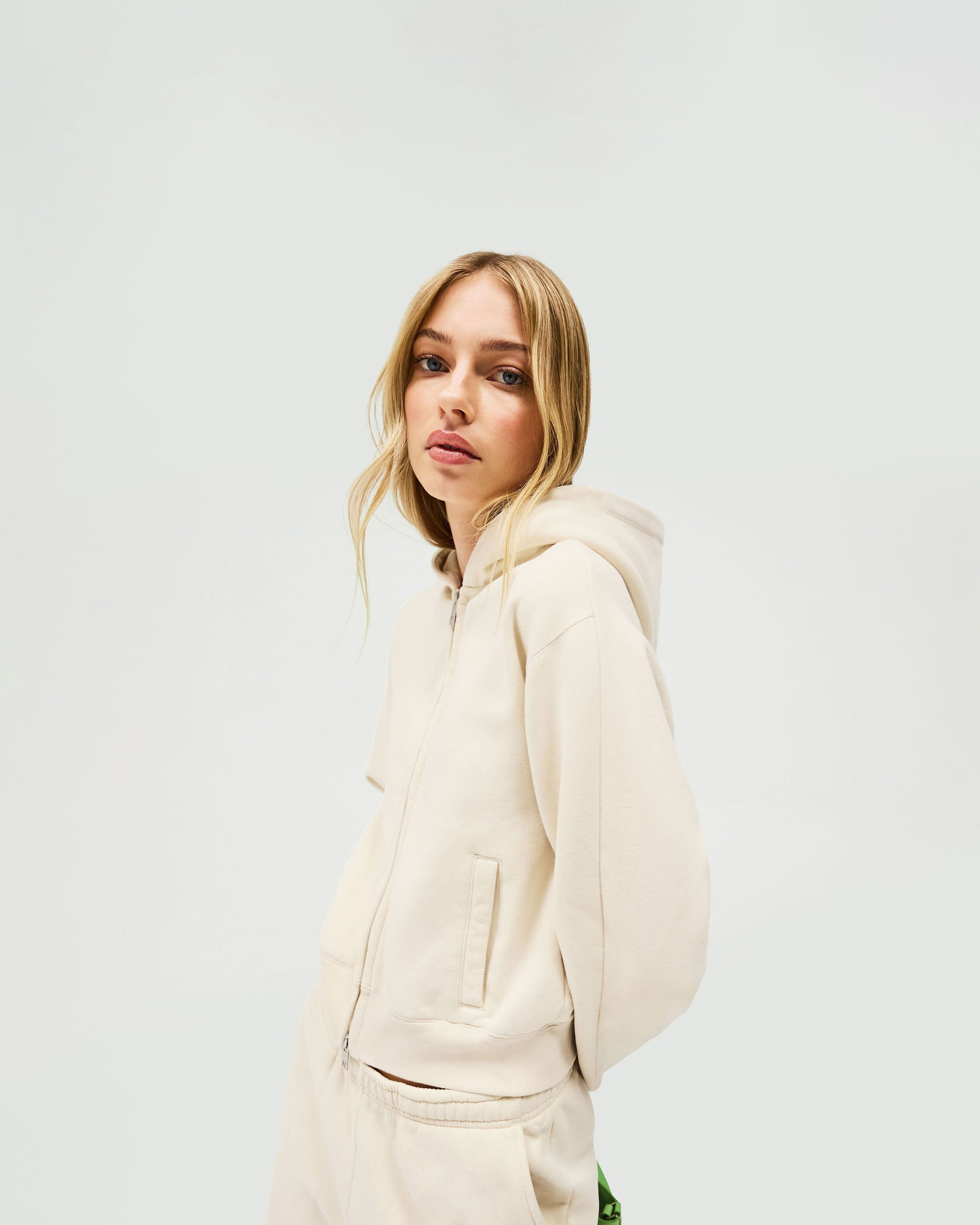 Back product image of a womens cream hoodie on a plain white background | Owners Club Slim Zip Hoodie in Oat Milk | Slim fit cropped zip hoodie with raglan sleeve detailing | Womens Owners Club Hoodies | Represent Clo