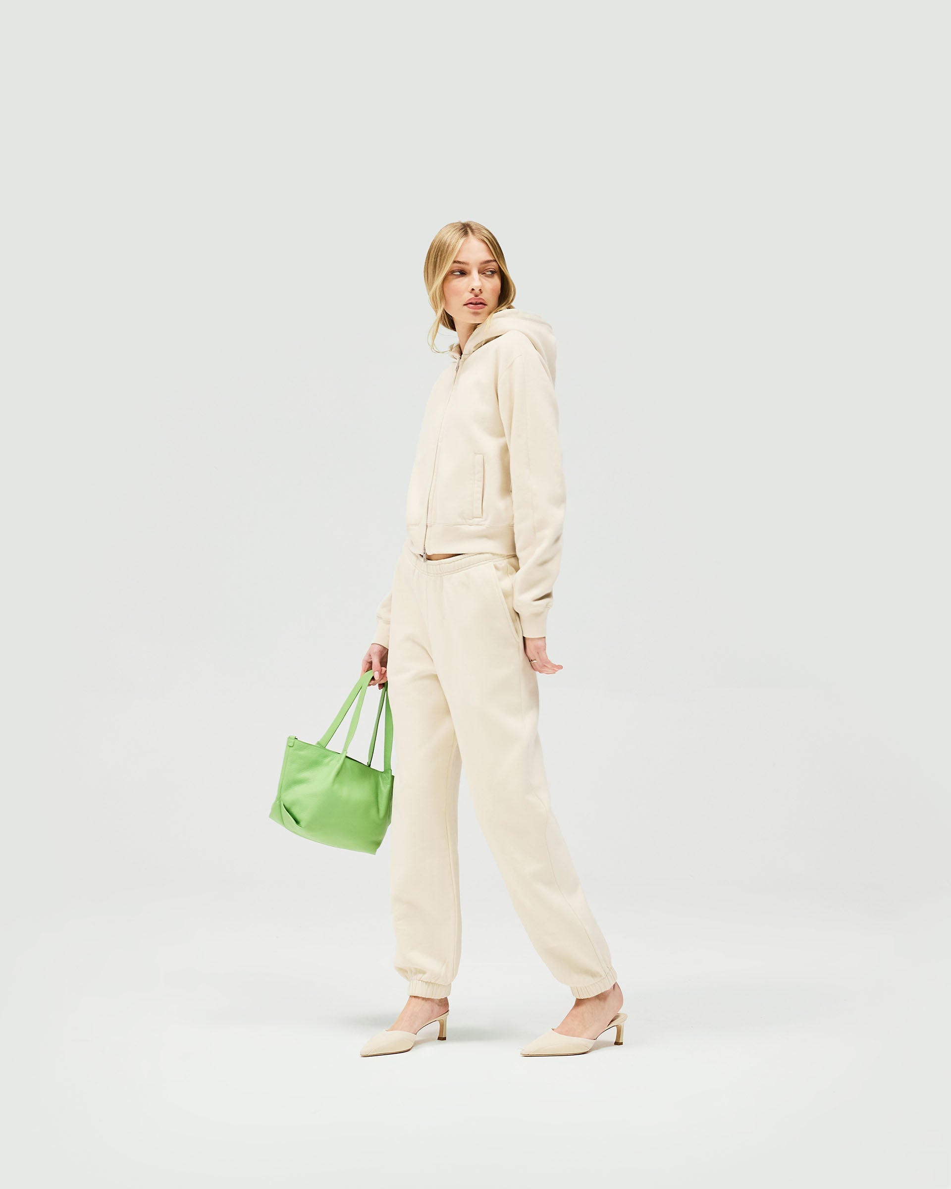 Back product image of womens oat track pants on a plain white background | Owners Club Track Pant in Oat Milk | Track pants with elasticised leg hem | SS23 Bottoms | Represent Clo