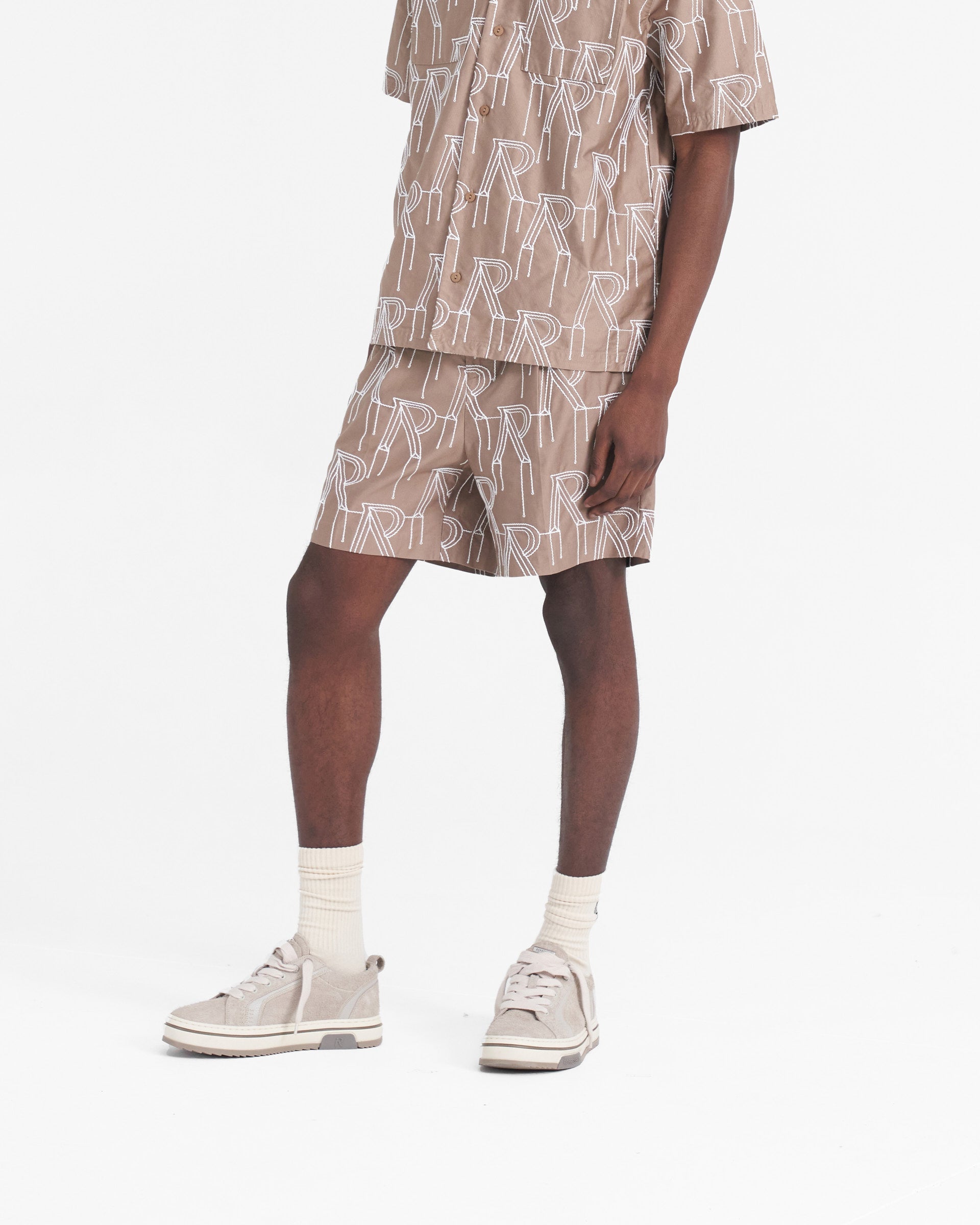 Back product image of mens taupe shorts on a plain white background | Embroidered Initial Tailored Short in Washed Taupe | Tailored shorts with raised chain stitch embroidery | SS24 Shorts | Represent Clo