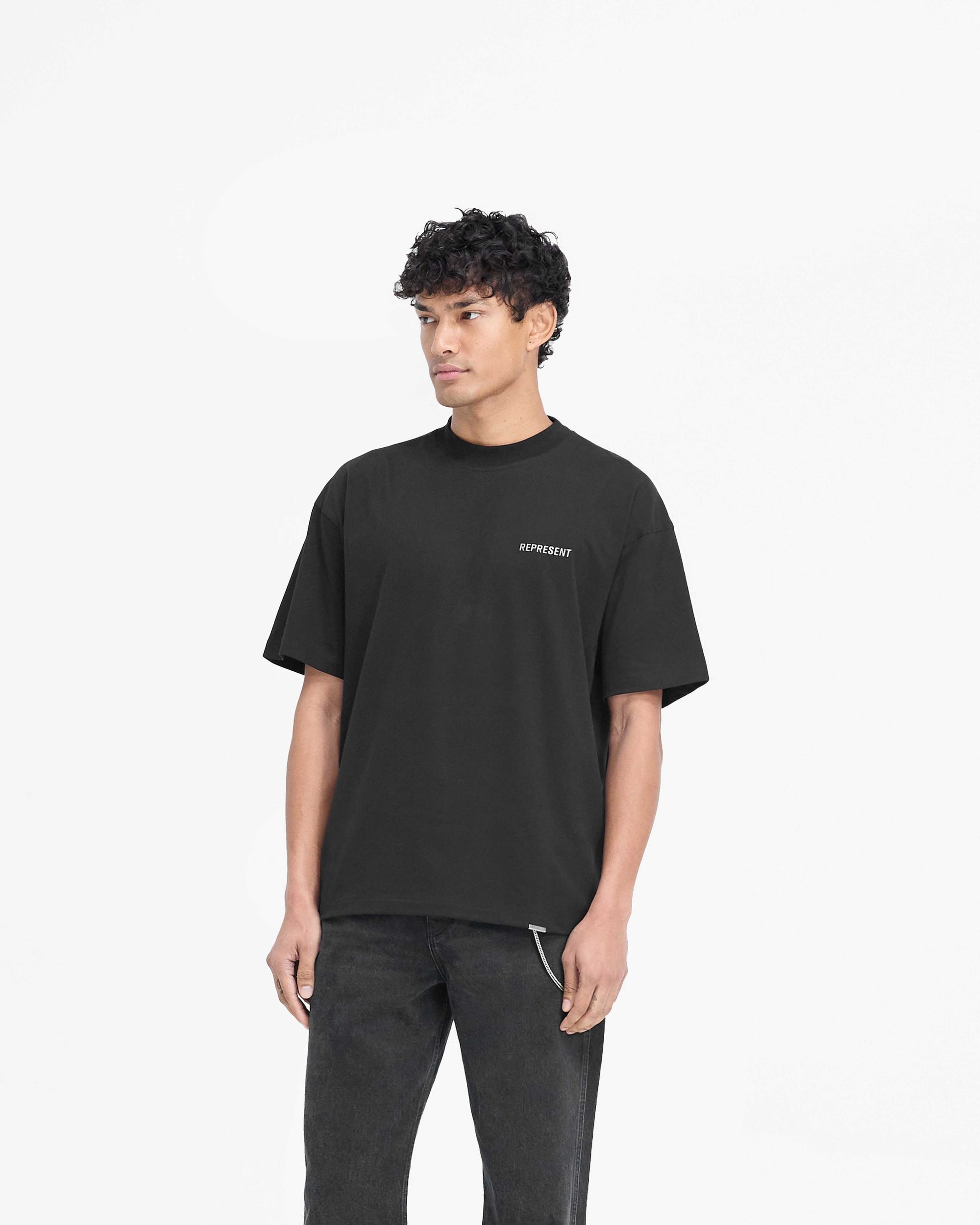 Back product image of a mens black t-shirt on a plain white background | Block Logo T-Shirt in Jet Black | Slightly oversized t-shirt with metal branding | PRE SS25 T-Shirts | Represent Clo