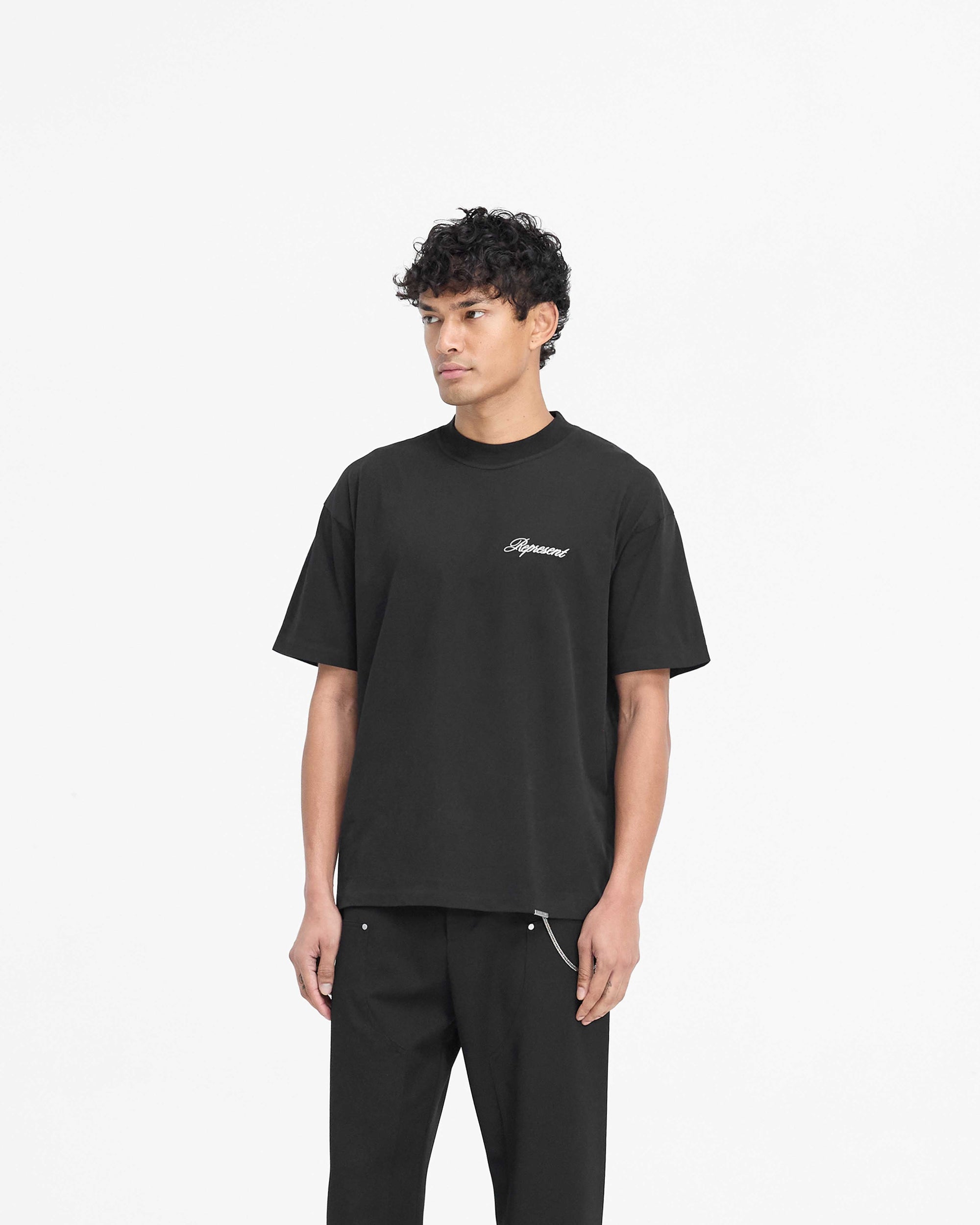 Back product image of a mens black t-shirt on a plain white background | Script Logo T-Shirt in Black | Slightly oversized t-shirt with high build embroidery | PRE SS25 T-Shirts | Represent Clo