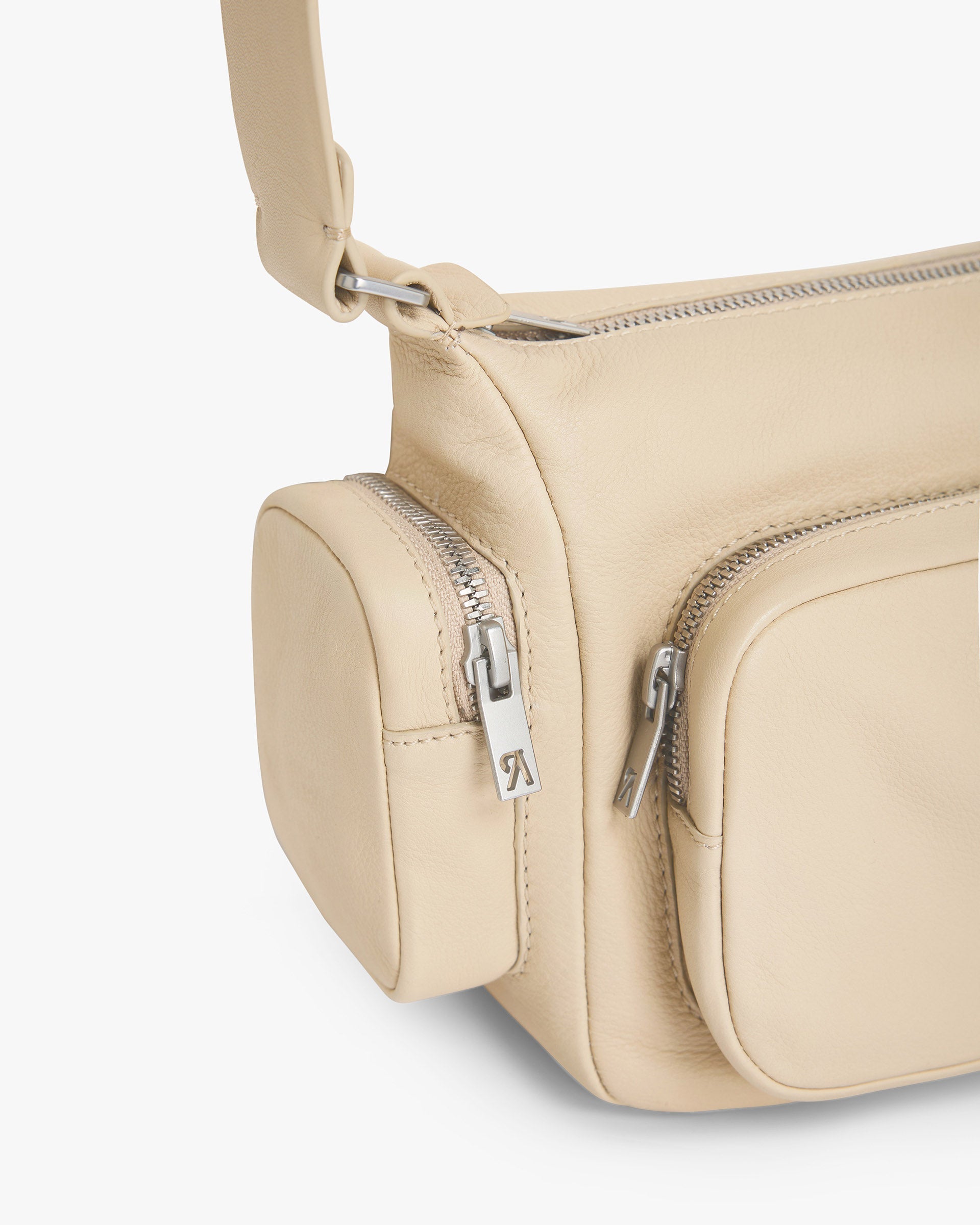 Back product image of a womens cream leather shoulder bag on a plain white background | Utility Shoulder Bag in Cream | Leather bag with zip fastening and exterior pockets | Womens SS25 Accessories | Represent Clo