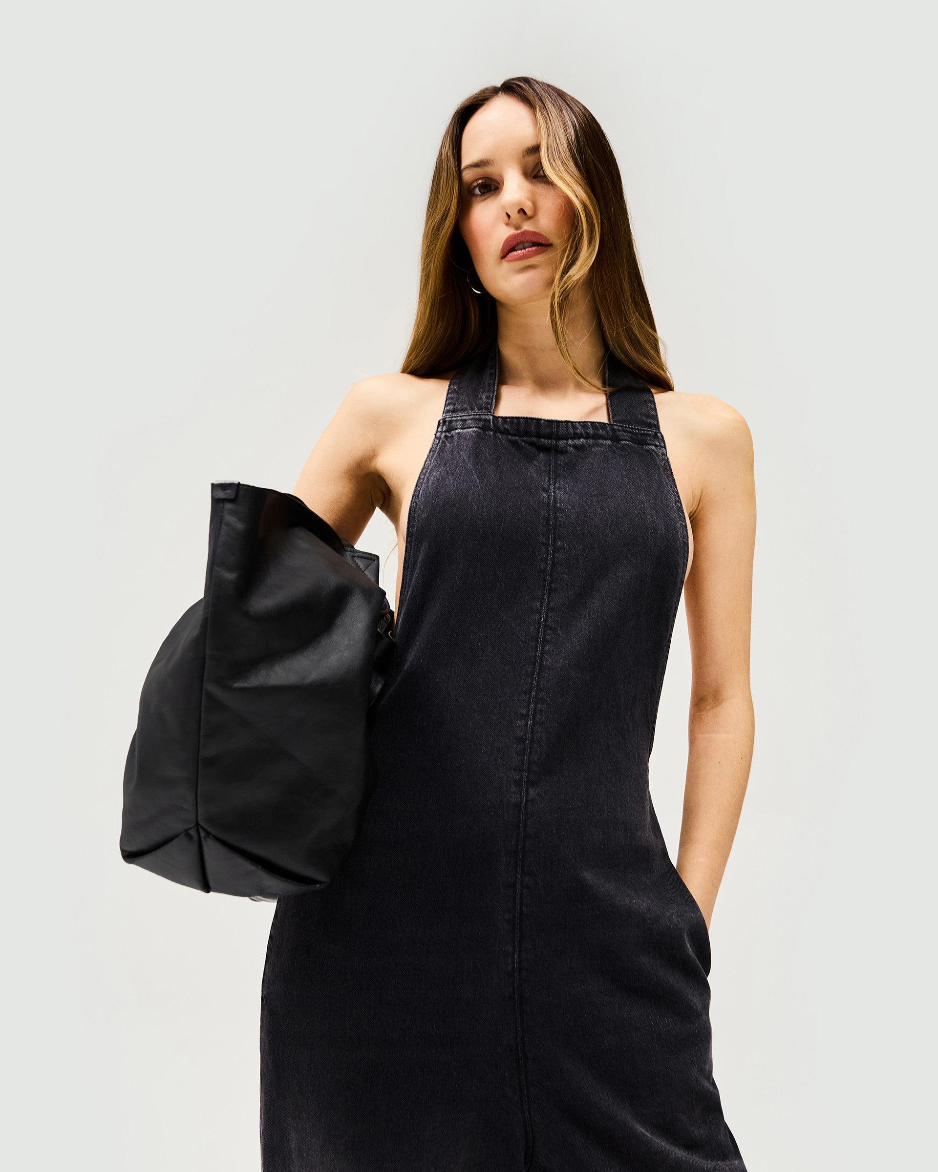 Back product image of a womens black denim jumpsuit on a plain white background | Voltage Denim Jumpsuit in Washed Black | Jumpsuit with wide leg and XL long back tie | Womens SS25 Denim | Represent Clo