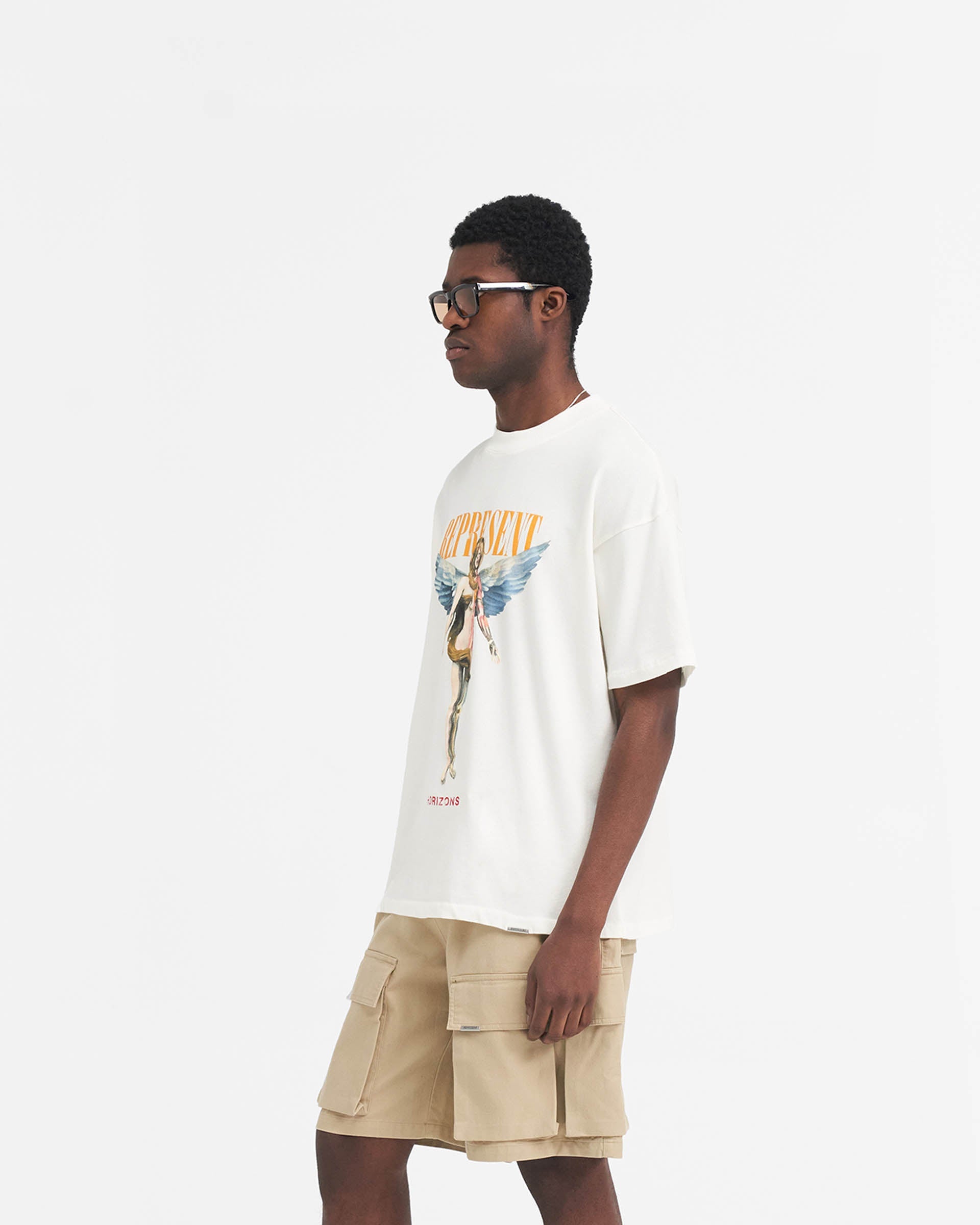 Back product image of a mens white t-shirt on a plain white background | Reborn T-Shirt in Flat White | Oversized t-shirt with Reborn graphic and Represent down the spine | SS24 T-Shirts | Represent Clo