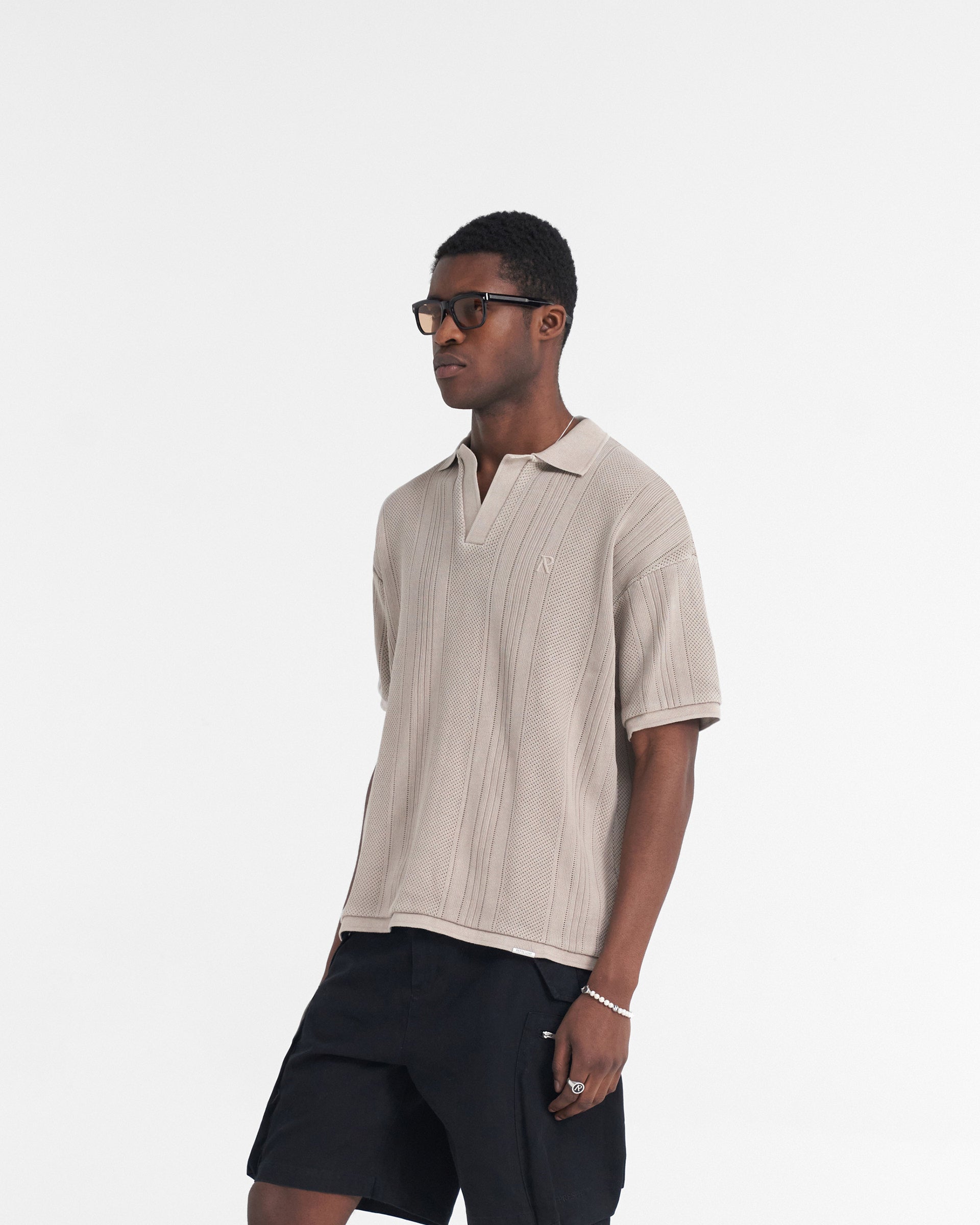 Back product image of a mens cashmere polo shirt on a plain white background | Open Stitch Polo in Cashmere | Polo shirt with open collar and embroidered logo | SS24 T-Shirts | Represent Clo