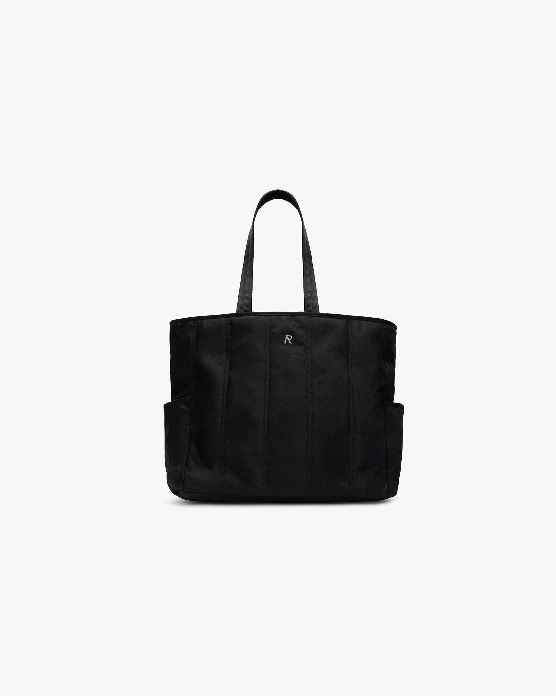 Front product image of a mens black quilted tote bag on a plain white background | Quilted Tote Bag in Jet Black | Spacious and stylish quilted accessory | SS25 Accessories | Represent Clo