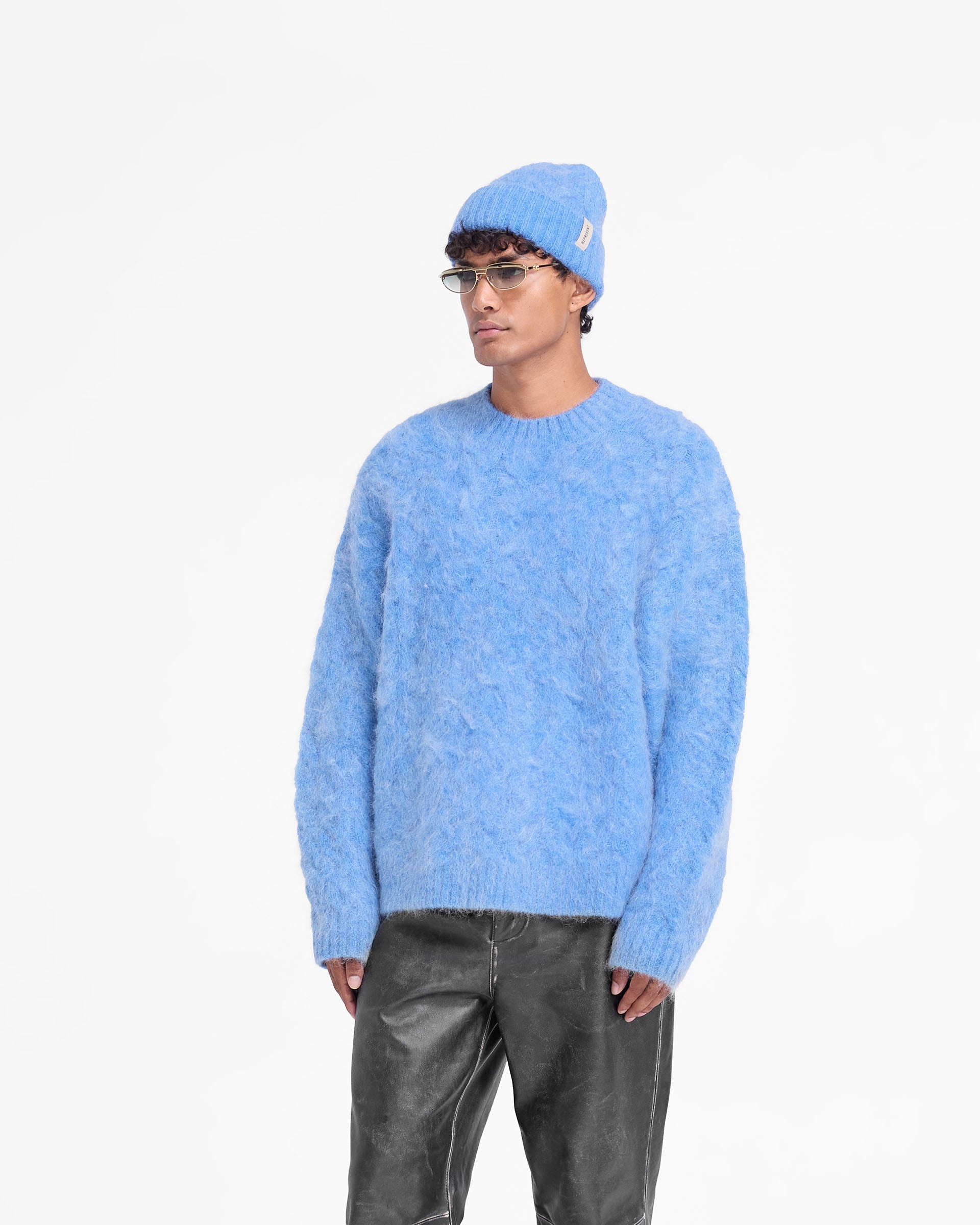 Back product image of a mens blue sweater on a plain white background | Cable Knit Sweater in Electric Blue | Oversized mohair knit sweater with ribbed hem and cuffs | FW24 Knitwear | Represent Clo