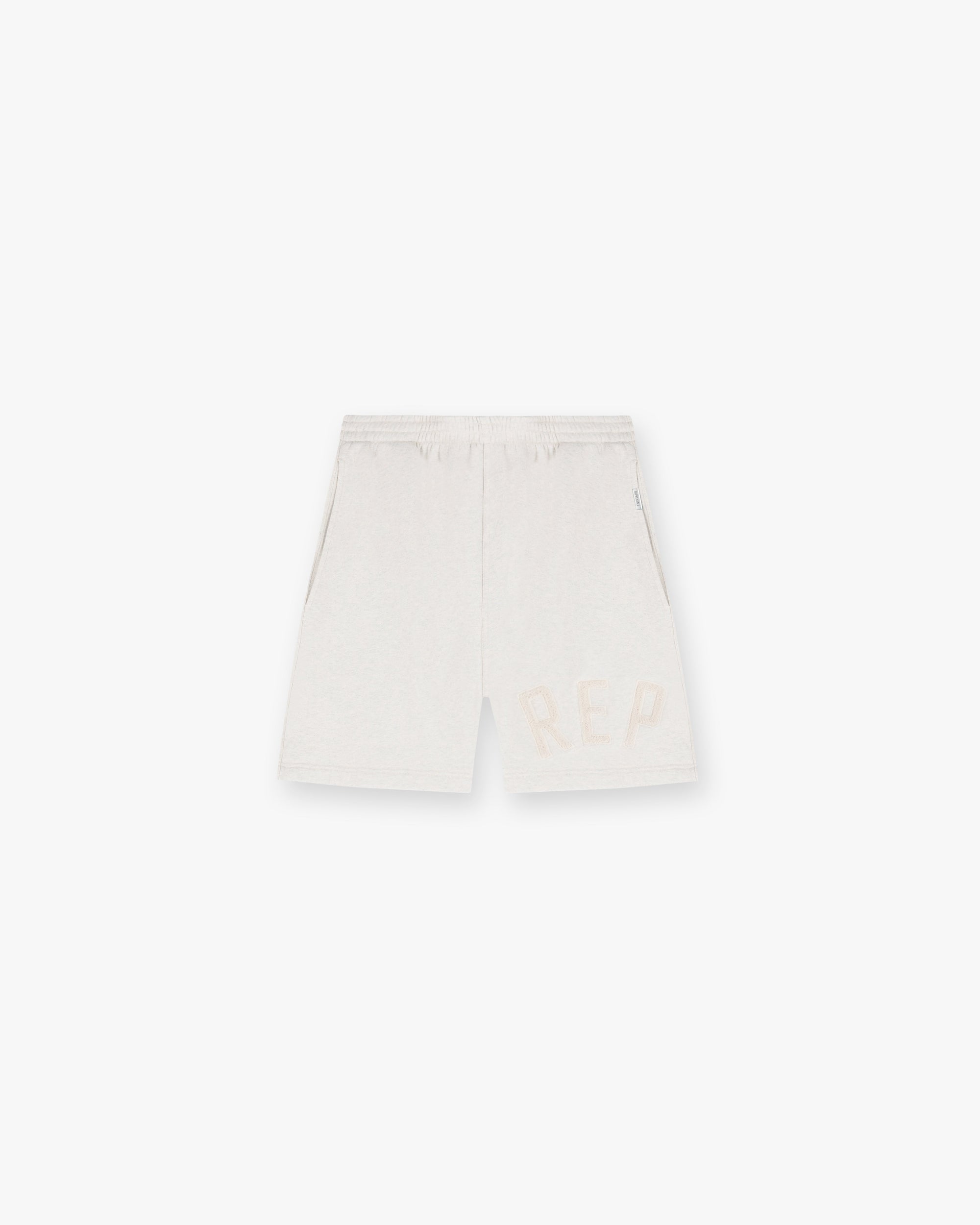 Front product image of mens cream shorts on a plain white background | Rep Applique Shorts in Cream Marl | Shorts with applique detailing | SS25 Shorts | Represent Clo