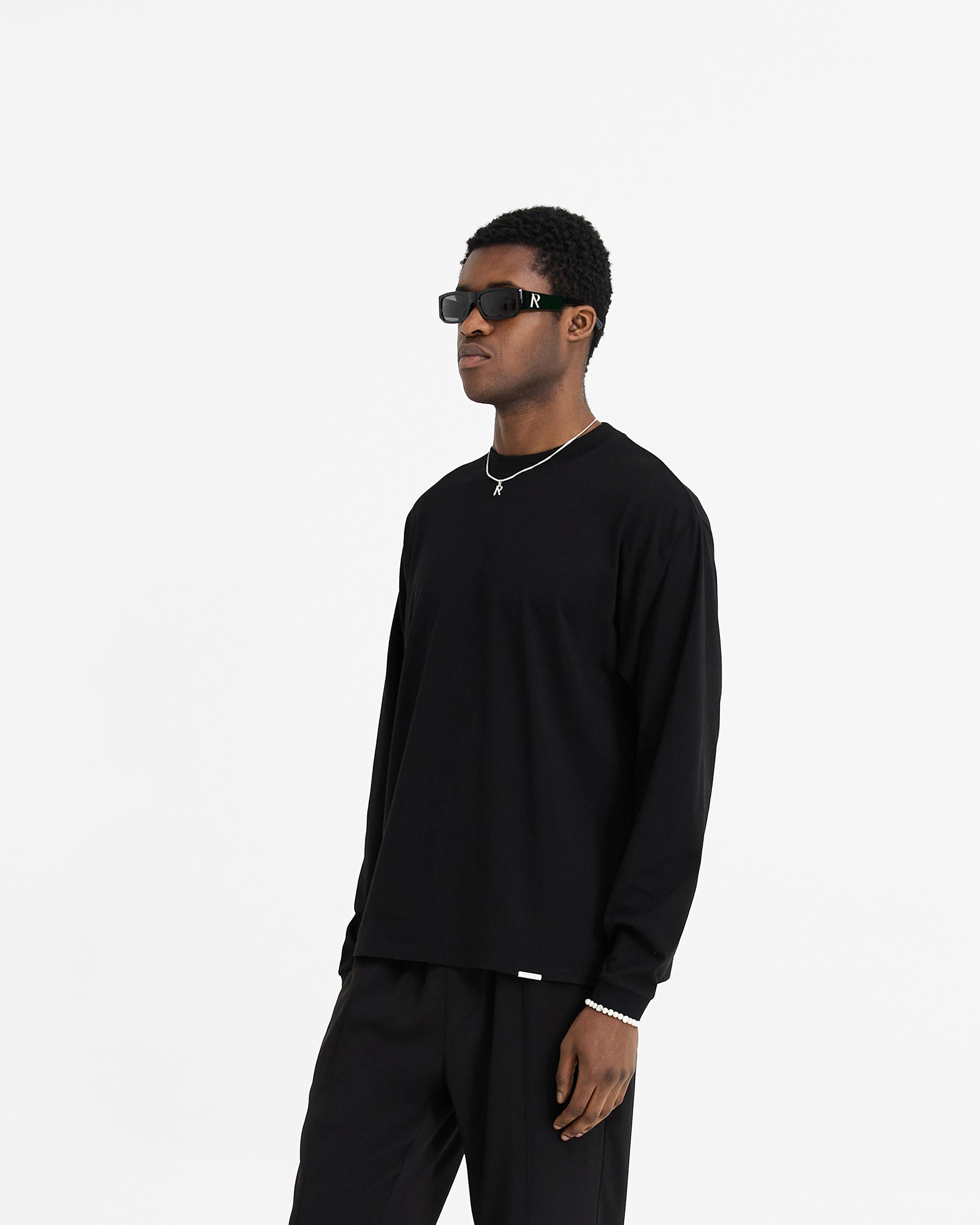 Back product image of a mens black long sleeve t-shirt on a plain white background | Initial Long Sleeve T-Shirt in Black | Regular fit t-shirt with embroidered details | Initial T-Shirts | Represent Clo