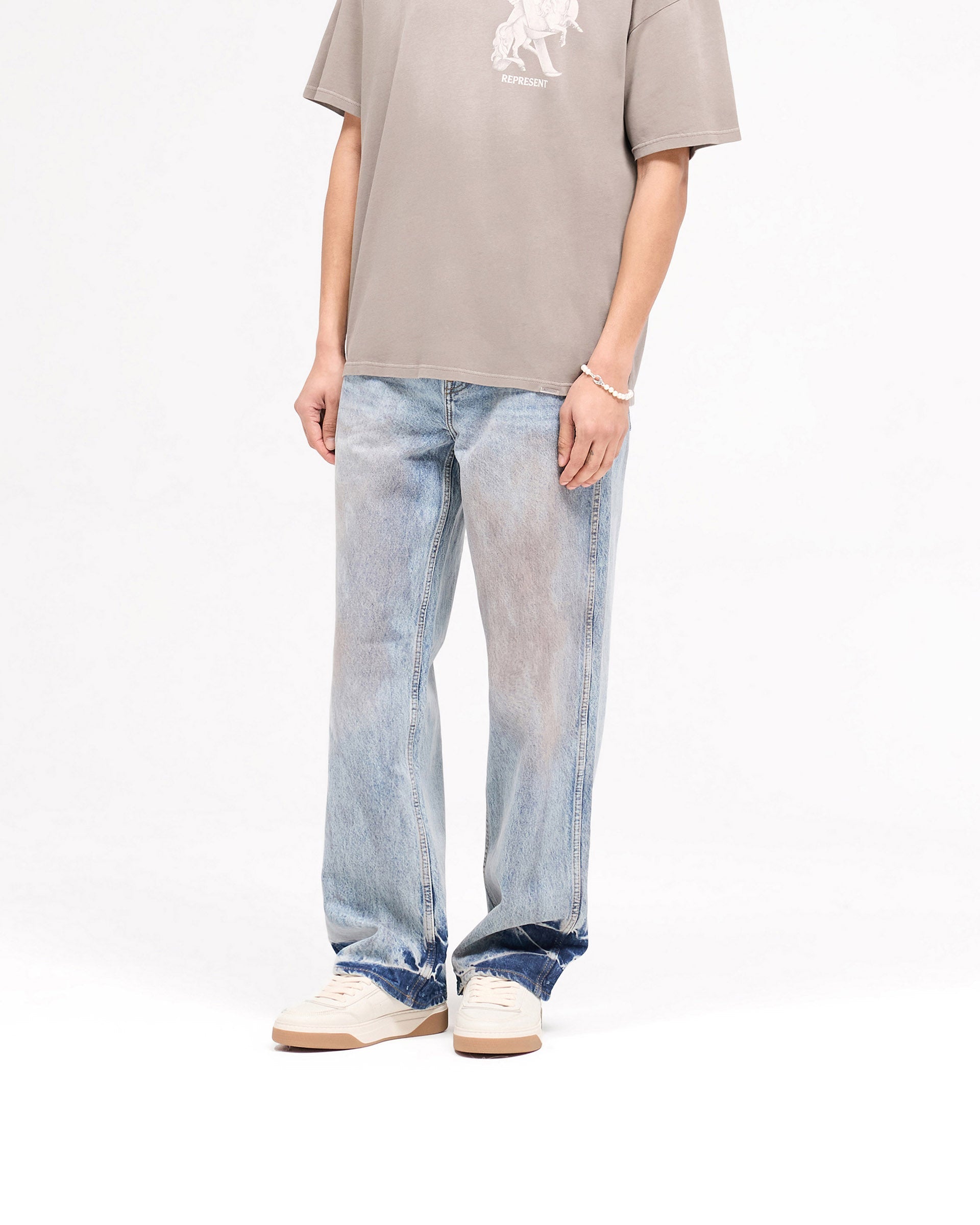 Back product image of mens blue denim jeans on a plain white background | R3 Baggy Denim in Mechanic Blue | Baggy fit jeans with initial embroidery | SS25 Denim | Represent Clo