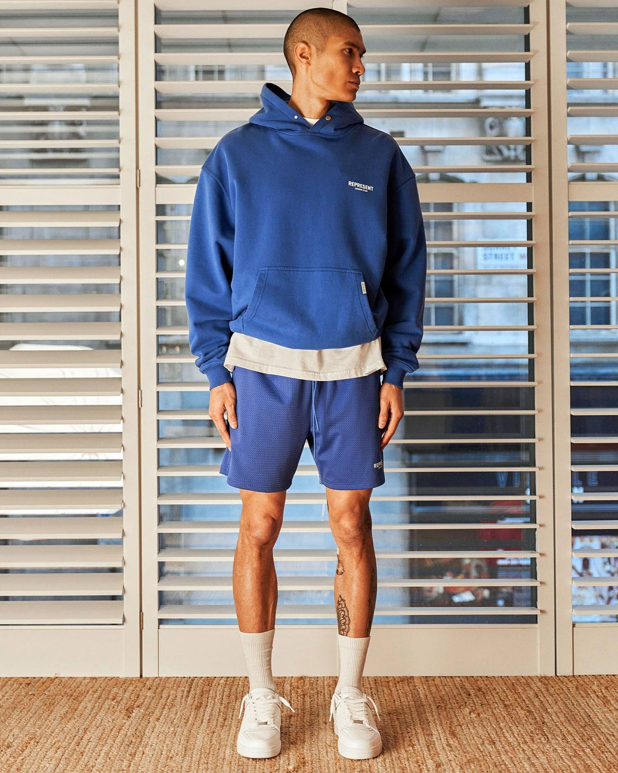 Back product image of mens blue mesh shorts on a plain white background | Owners Club Mesh Shorts in Cobalt | Mesh shorts with welt pockets and elasticated waist | Owners Club Shorts | Represent Clo