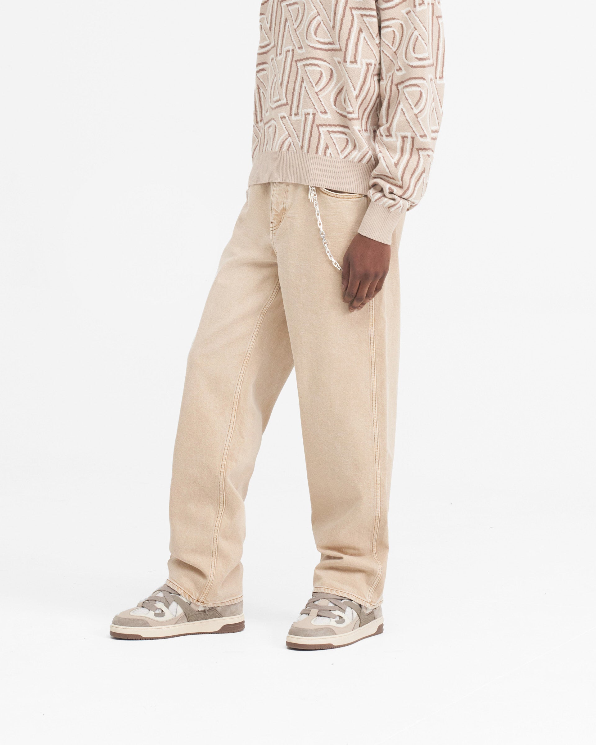 Back product image of mens beige denim jeans on a plain white background | R3 Baggy Denim in Dirt Cashmere | Baggy fit denim jeans with embroidered pocket detail | SS24 Denim | Represent Clo