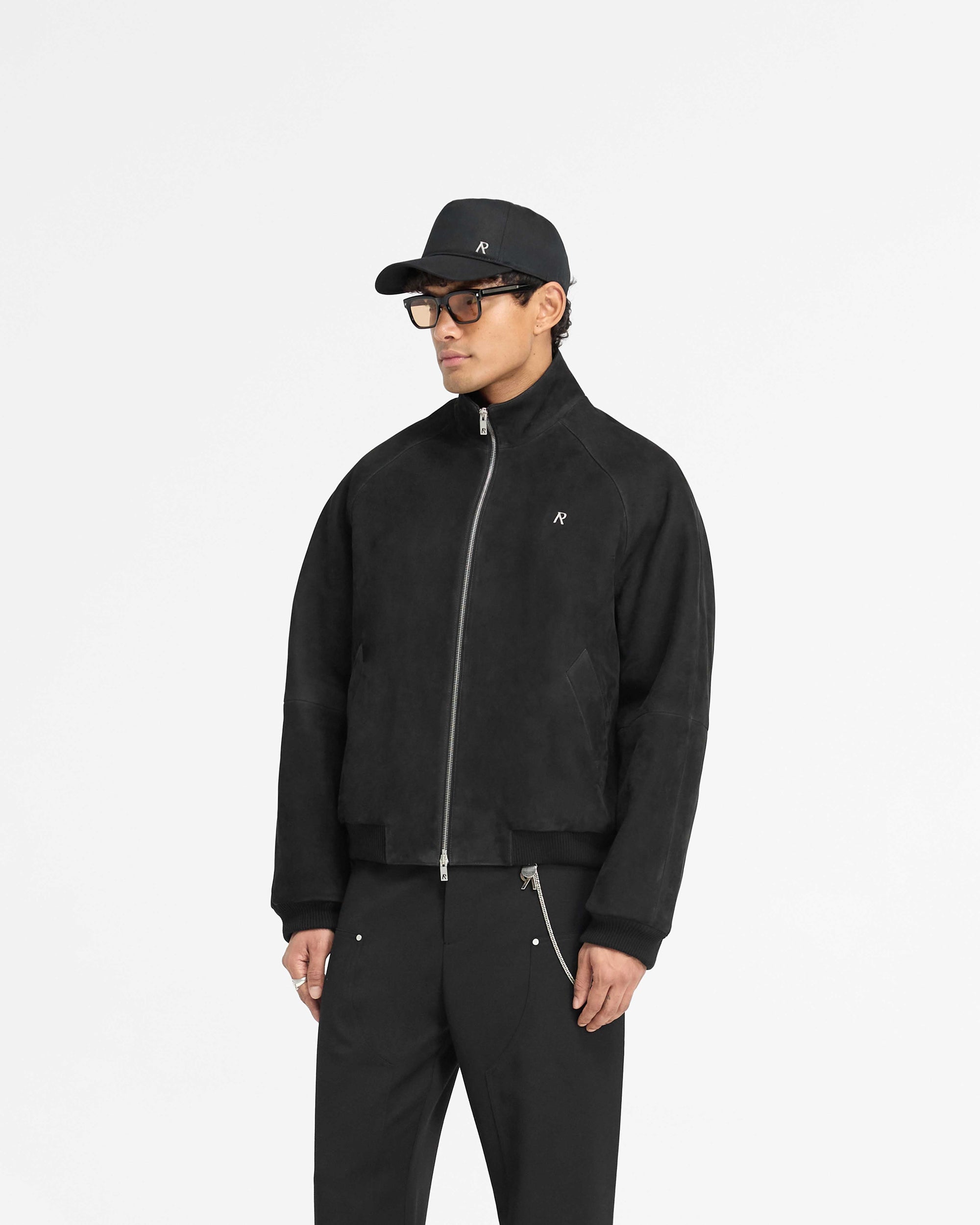 Back product image of a mens black suede bomber jacket on a plain white background | Suede Bomber in Black | Bomber jacket with ribbed hem and funnel neck | PRE SS25 Outerwear | Represent Clo