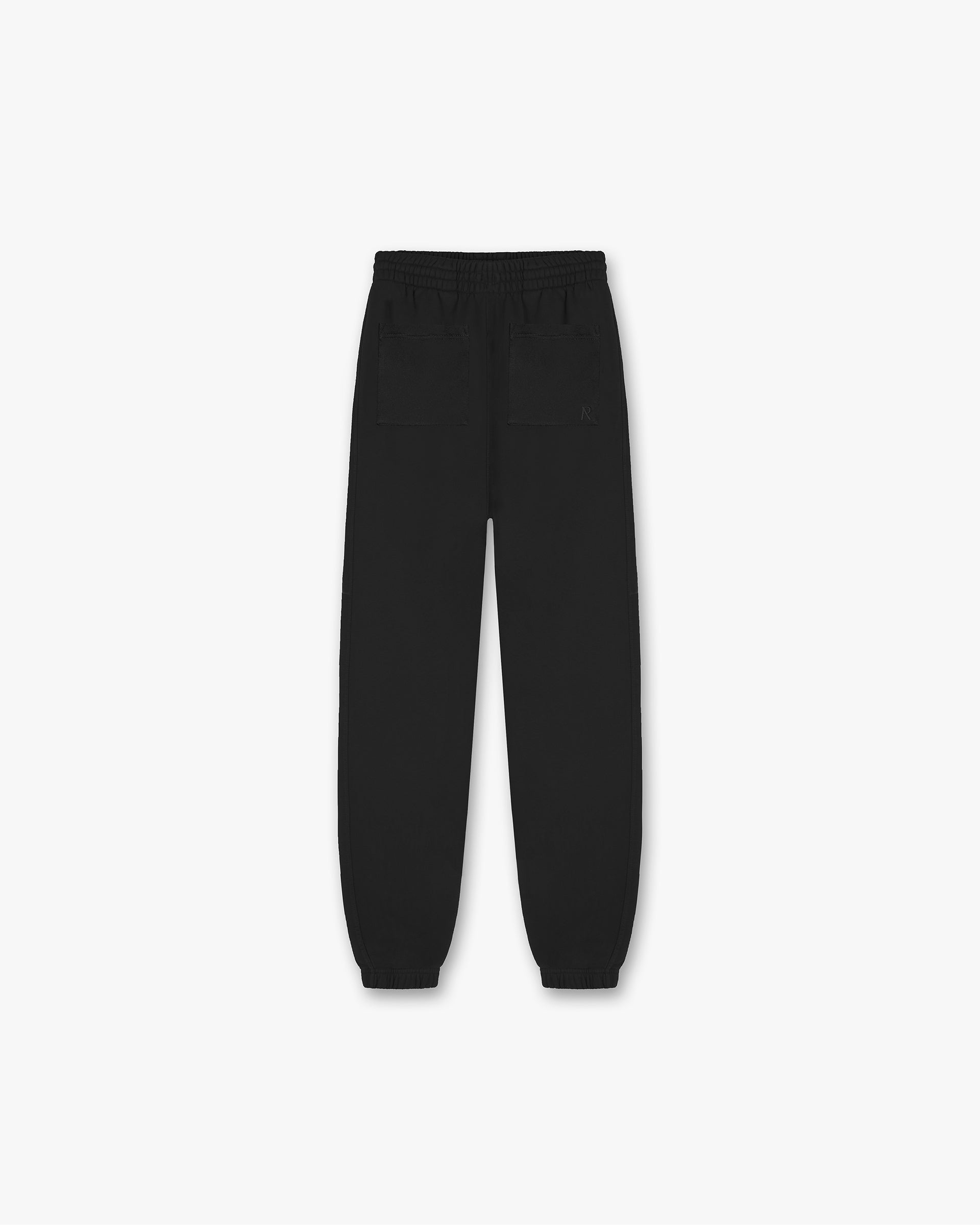 Back product image of mens black sweatpants on a plain white background | Initial Cuffed Sweatpants in Black | Heavyweight loopback cotton sweatpants with elasticated cuffs | Initial Pants | Represent Clo
