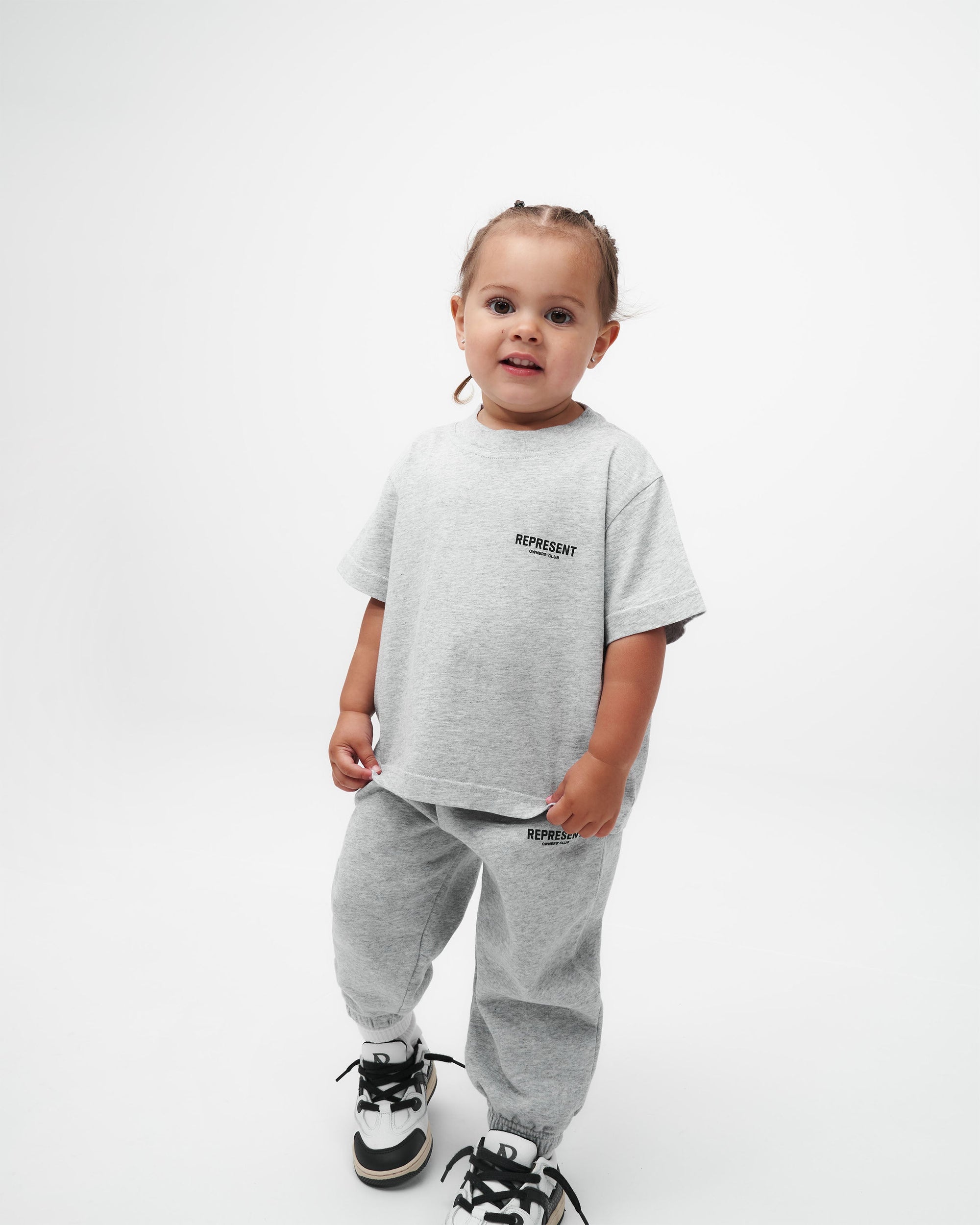 Back product image of kids grey sweatpants on a plain white background | Represent Mini Owners Club Sweatpants in Ash Grey | Sweatpants with elasticated waistband and cuffs | Owners Club Pants | Represent Clo