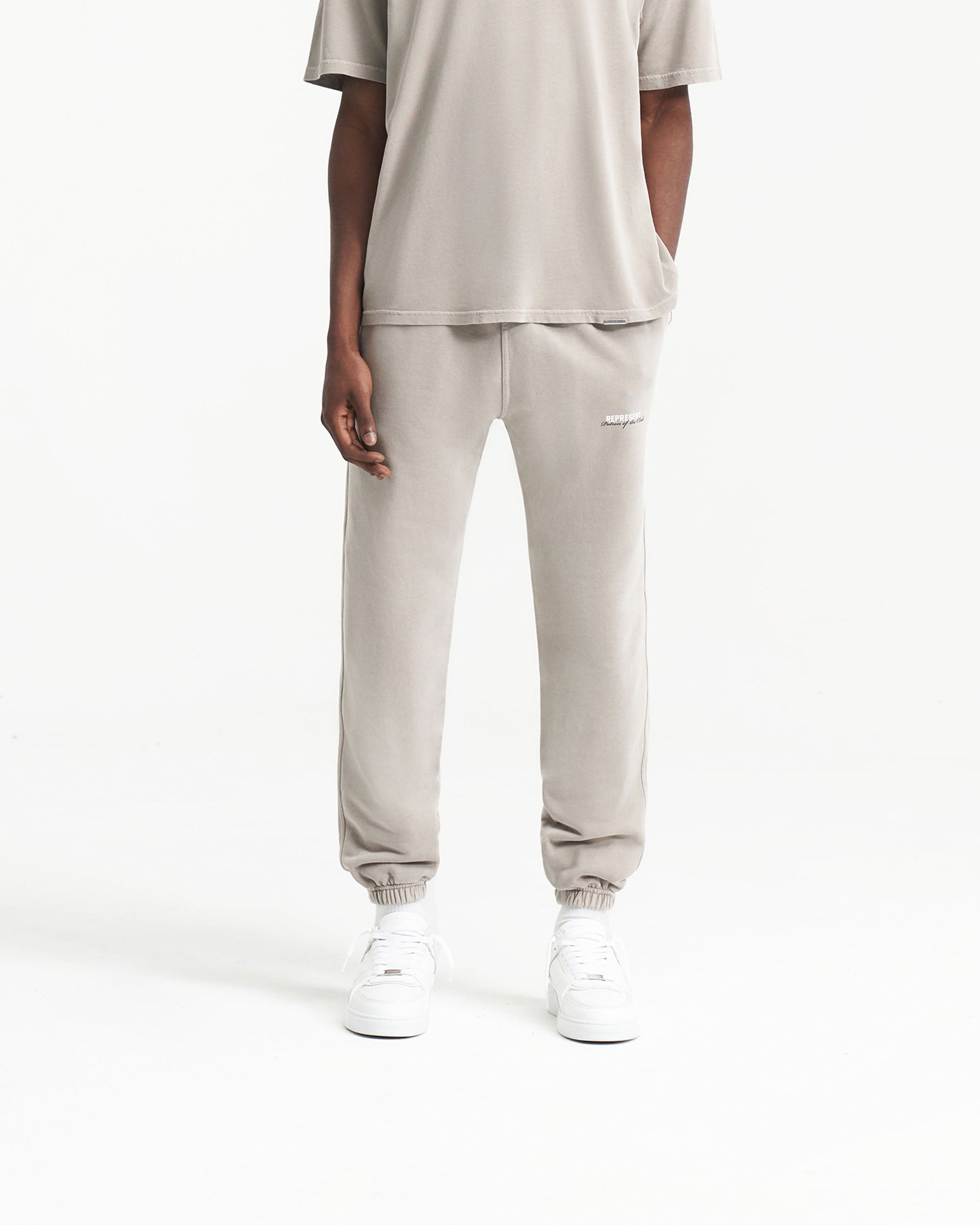 Back product image of mens grey sweatpants on a plain white background | Patron Of The Club Sweatpant in Mudstone | Sweatpants with elasticated waistband and cuffs | Patrons Pants | Represent Clo
