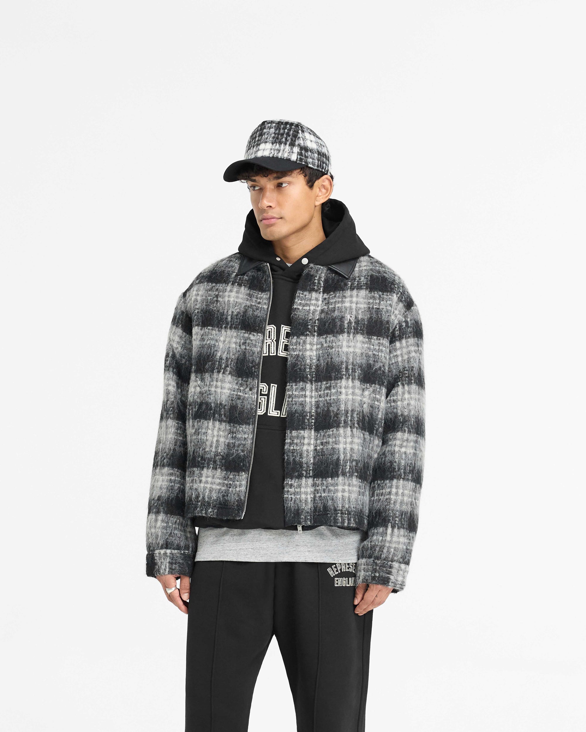 Back product image of a mens black check jacket on a plain white background | Flannel Check Overshirt in Jet Black | Oversized boxy hairy flannel check shirt with double zip closure | PRE SS25 Shirts | Represent Clo