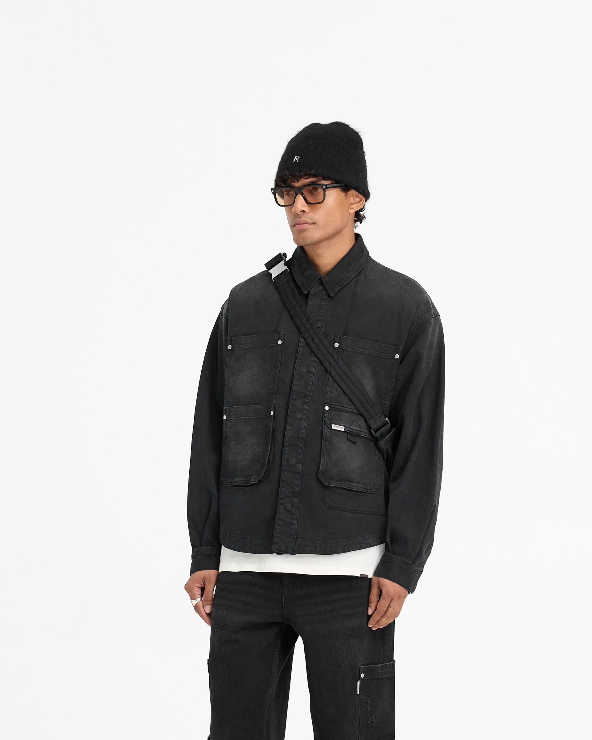 Back product image of a mens black shirt on a plain white background | Workshop Shirt in Washed Black | Shirt with flap pockets and popper closures | FW24 Shirts | Represent Clo